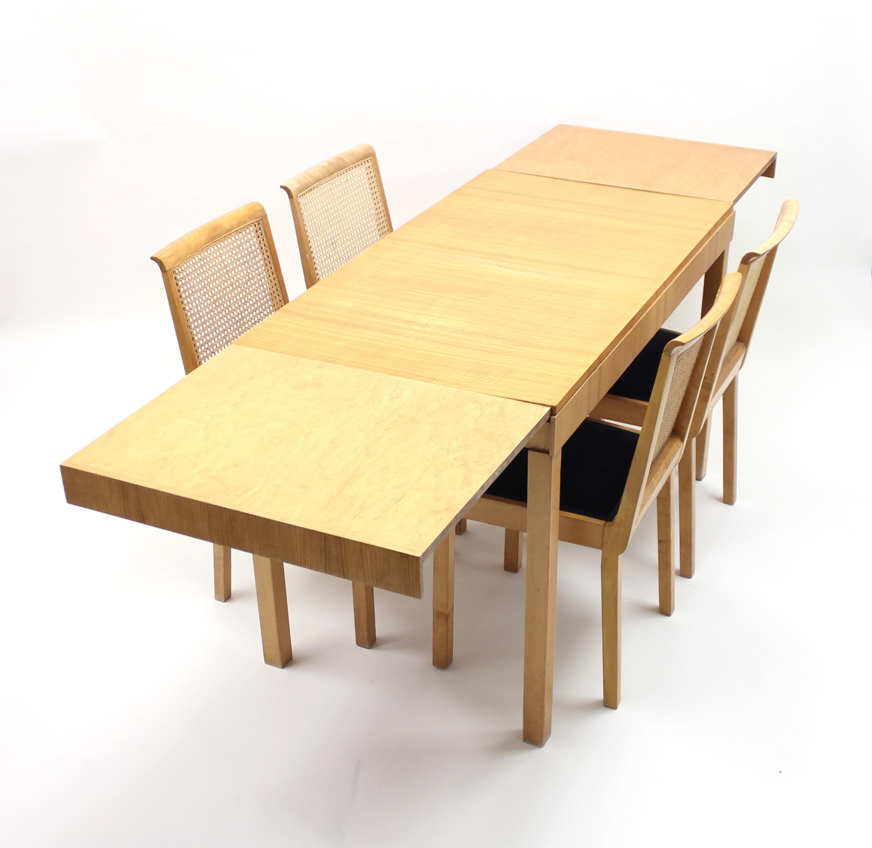 Rare dining set designed by Axel Einar Hjorth for Nordiska Kompaniet (NK) in the first half of the 1930s. It features as set of 4 Corall chairs and a Typenko table with two extra leafs tucked underneath the table top. The table measures 120 cm in