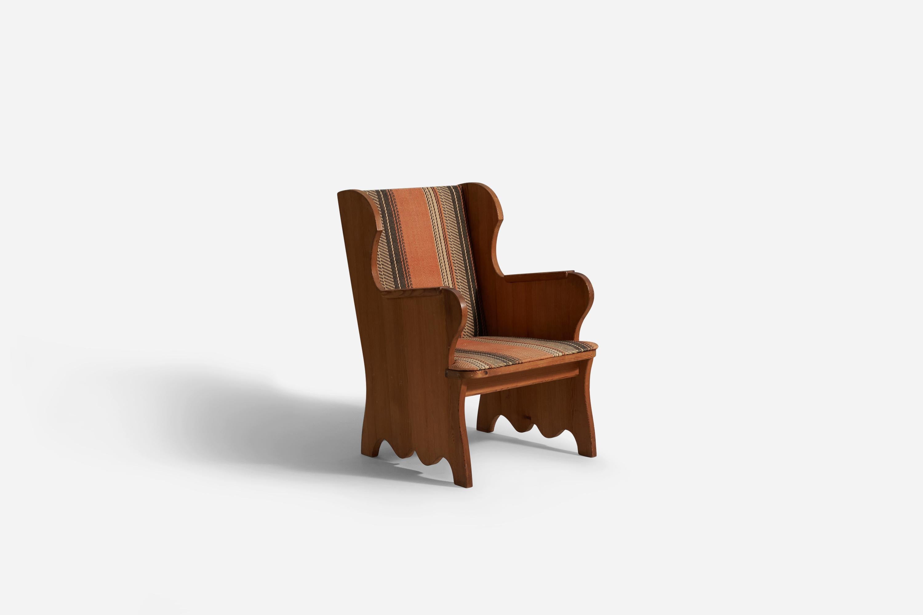 A stained pine and brown fabric lounge chair model 