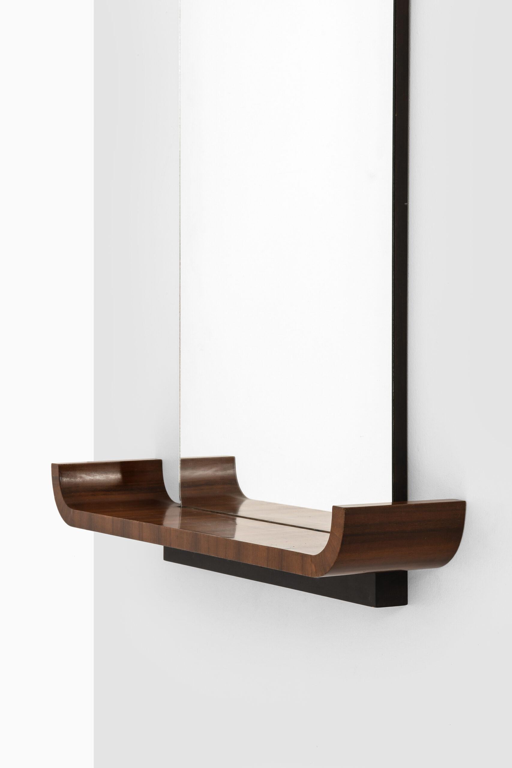 Rare mirror with shelf model Typenko designed by Axel Einar Hjorth. Produced by Nordiska Kompaniet in Sweden.