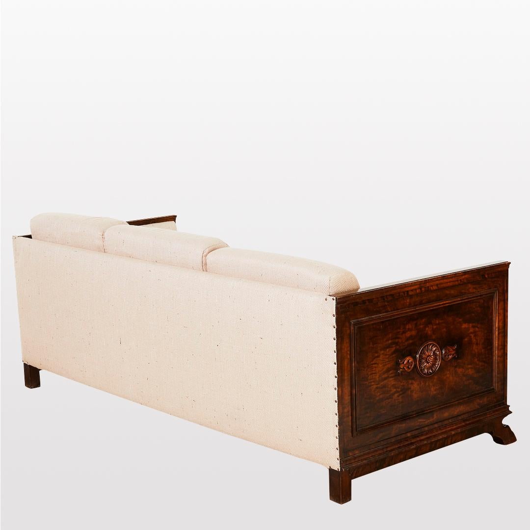 An unique piece by Axel Einar Hjorth from his Swedish Art Deco or Swedish Grace period. A 3 seater sofa. Exquisite carvings on the sides. Feet look like a lion's paw. The model is part of his Roma series. Made of Birch wood and reupholstered.