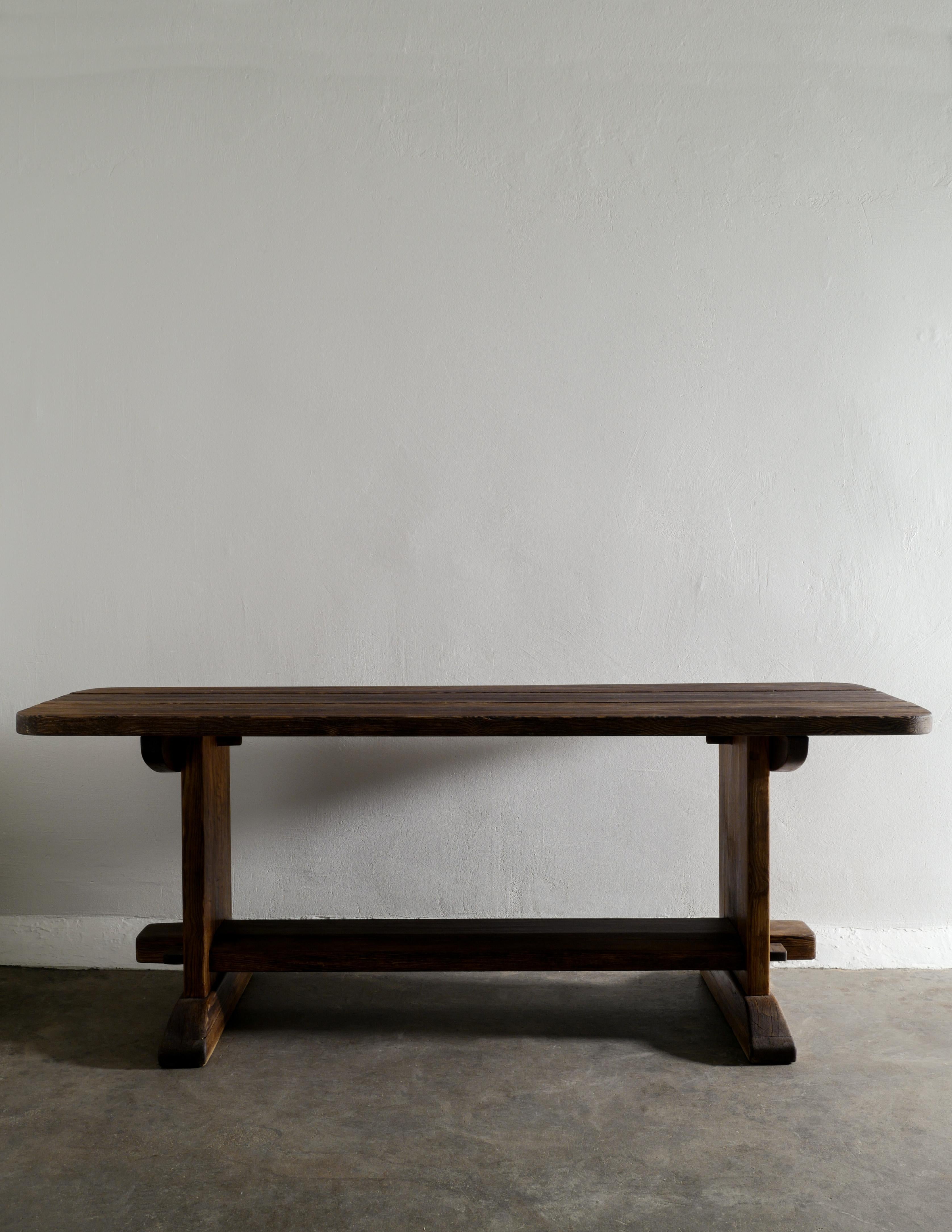 Very rare dining / console table in solid stained pine designed by Axel Einar Hjorth and produced by Nordiska Kompaniet in Stockholm 1932. In good vintage and original condition with patina from age and use. Perfect as a smaller dining table in or