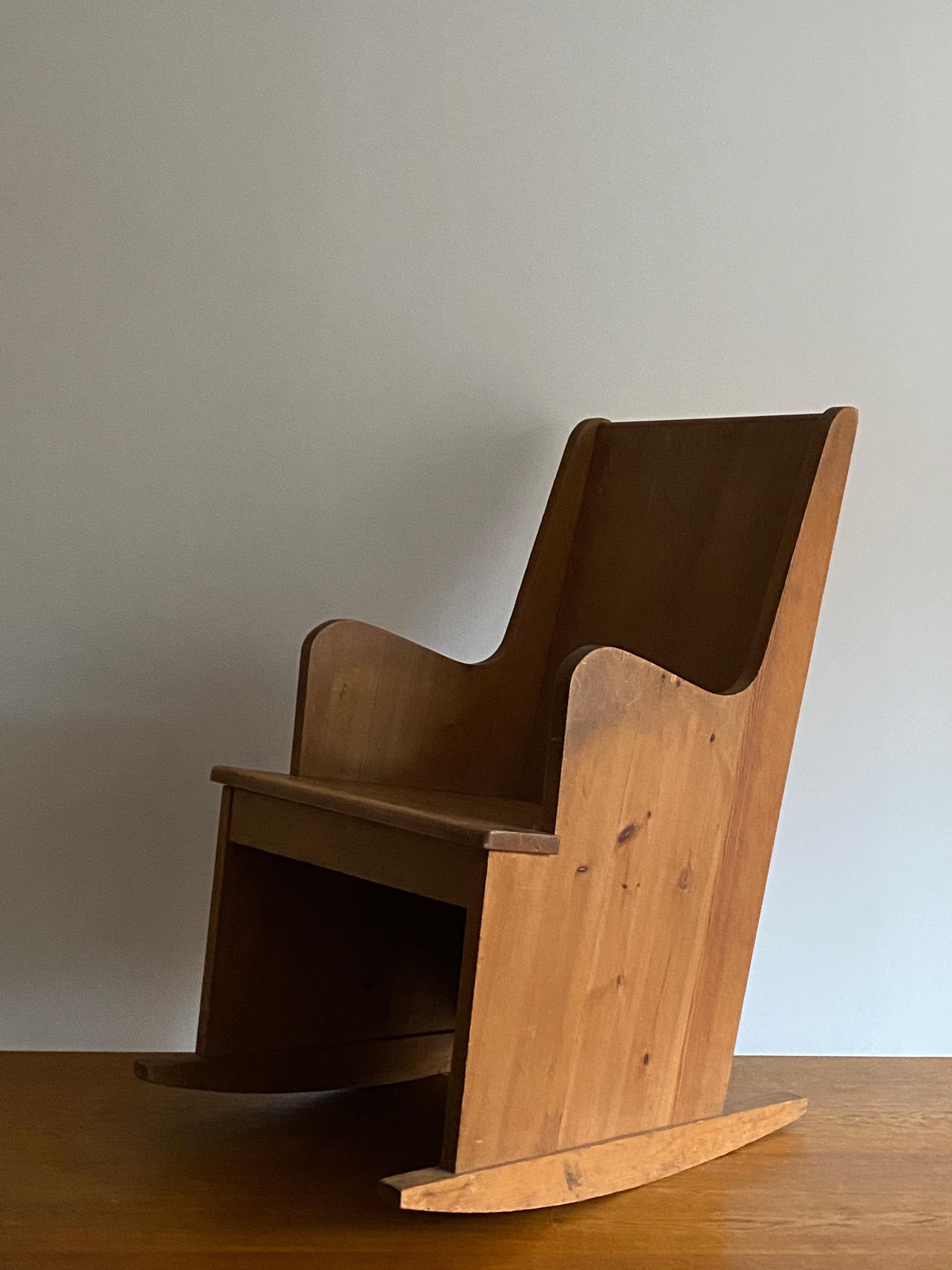 A unique custom made rocking chair, in pine and pine plywood. Custom produced by Nordiska Kompaniet for a Swedish vacation house completed in 1937. 

This custom example with higher back.

Other designers of the period include Kaare Klint,