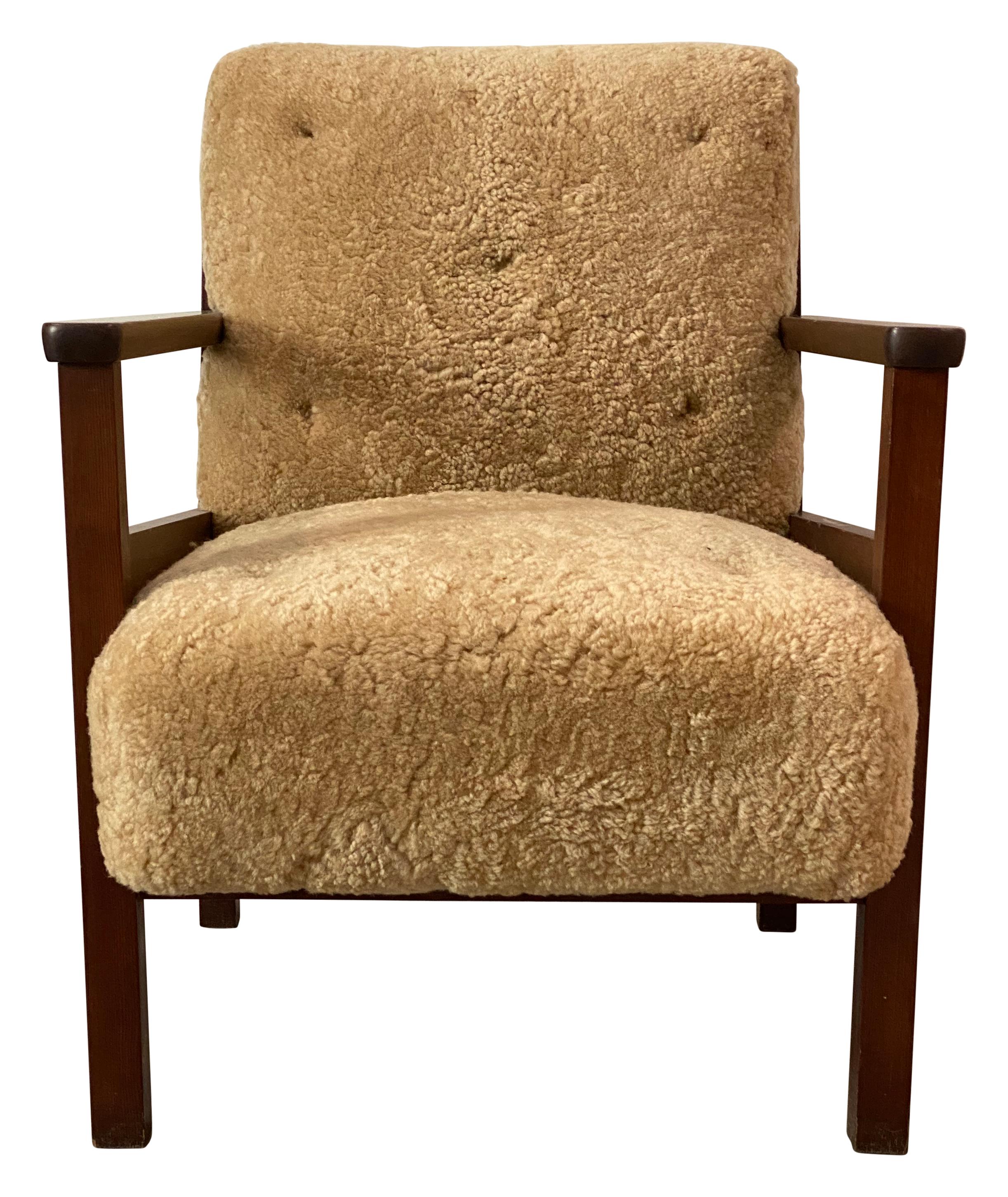 Axel Einar Hjorth Wärmdo lounge chair in a beige sheepskin and stained pine produced by Nordiska Kompaniet in 1937.