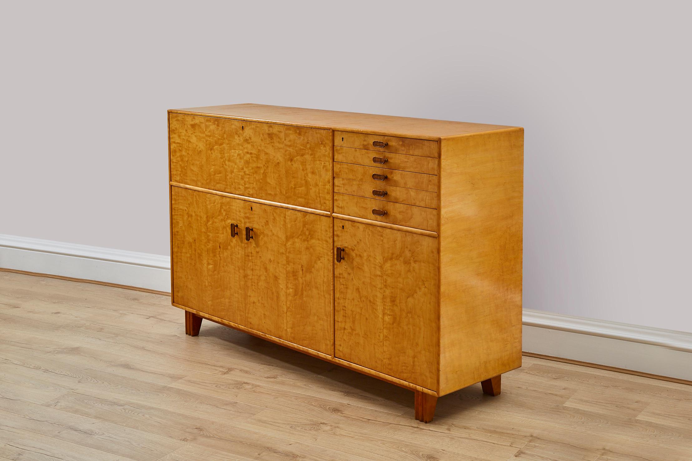 Art Deco birch wood cabinet / sideboard, designed by Axel Larsson for A.B. Svenska Möbelfabrikerna Bodafors. 

This practical and stylish piece will fit everything you need. The Swedish design is slick and sophisticated with the makers mark inside