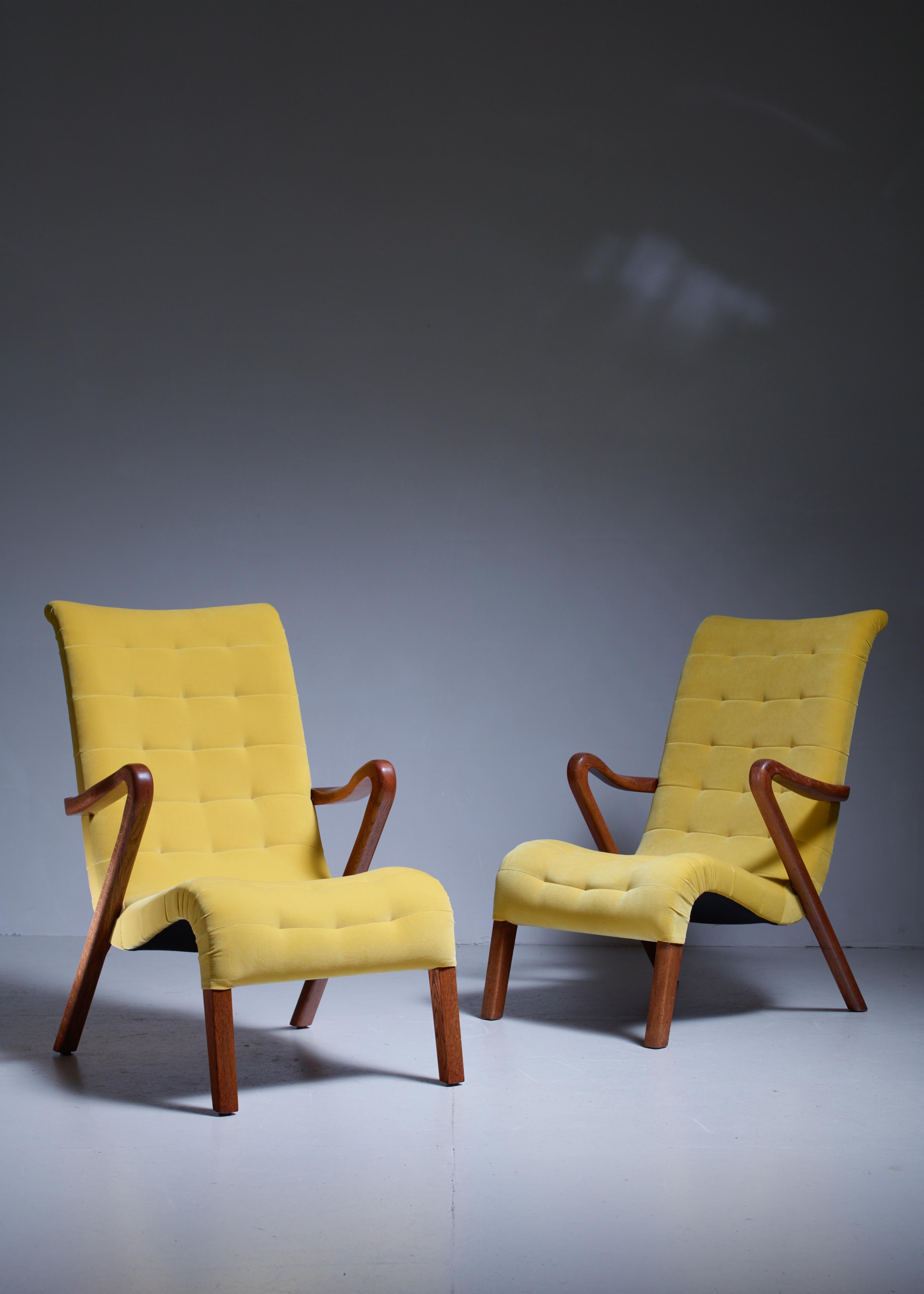 A pair of high back easy chairs with an oak frame by Axel Larsson. The seating and the armrests are beautifully curved.
The chairs have been professionally reupholstered in our in-house atelier with a yellow wool velour.