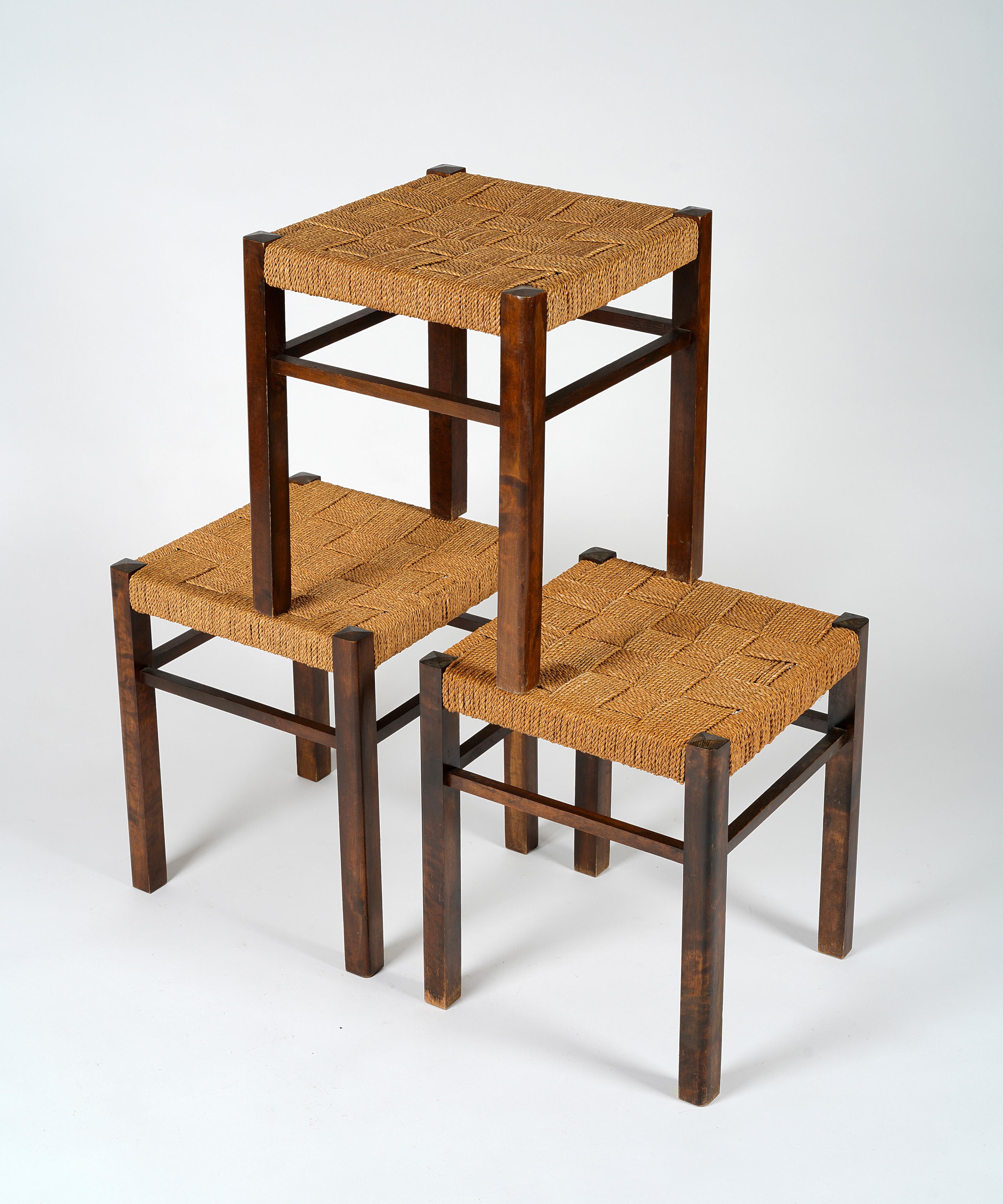 Swedish Axel Larsson, set of three stools in stained birch and woven seagrass, 1930s For Sale