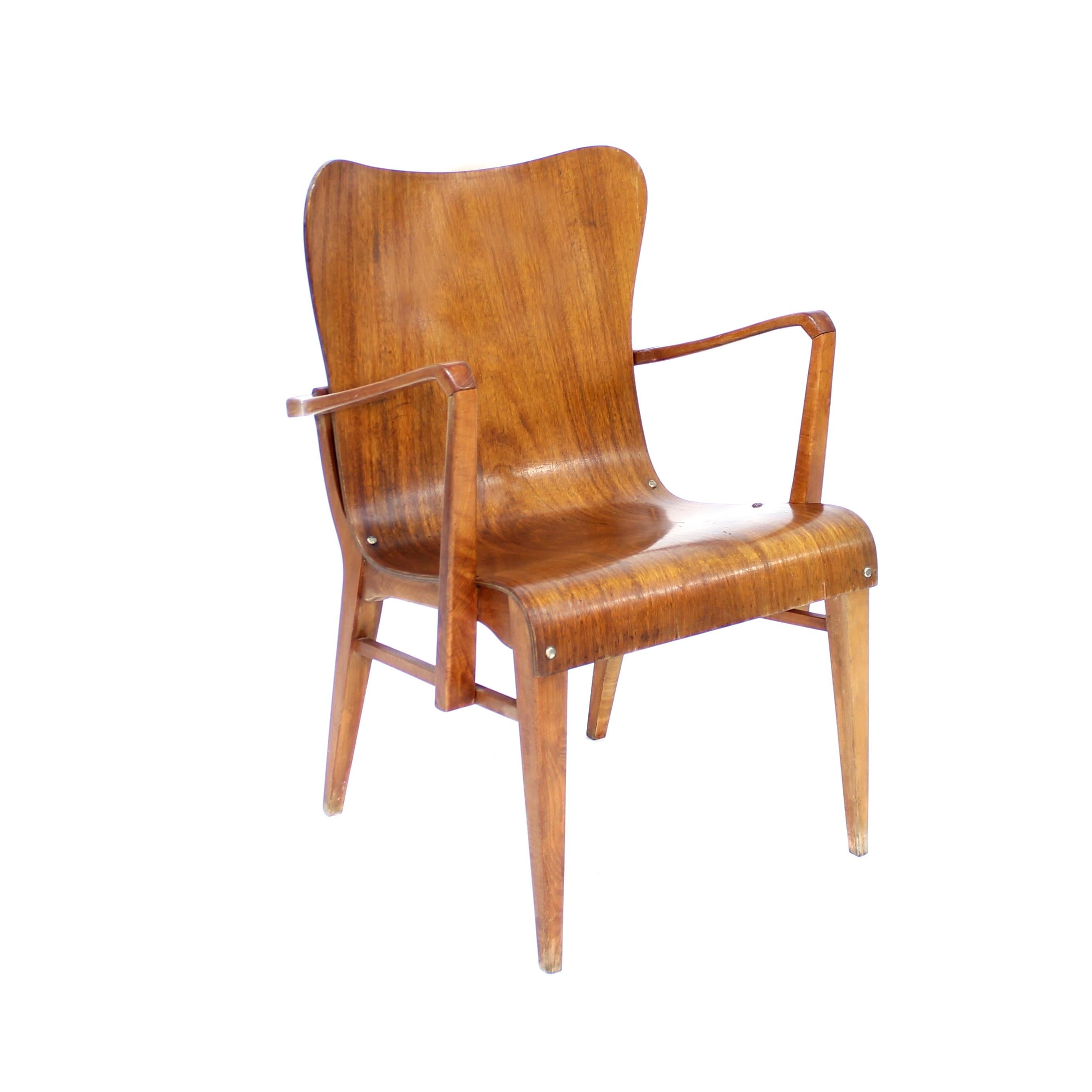 Semi rare armchair designed by Axel Larsson for Swedish firm Svängsta Stilmöbler and produced in the 1950s. Seating element of stained and molded teak on a stained beech frame. This is one of the more unusual designs by Larsson since he manly worked