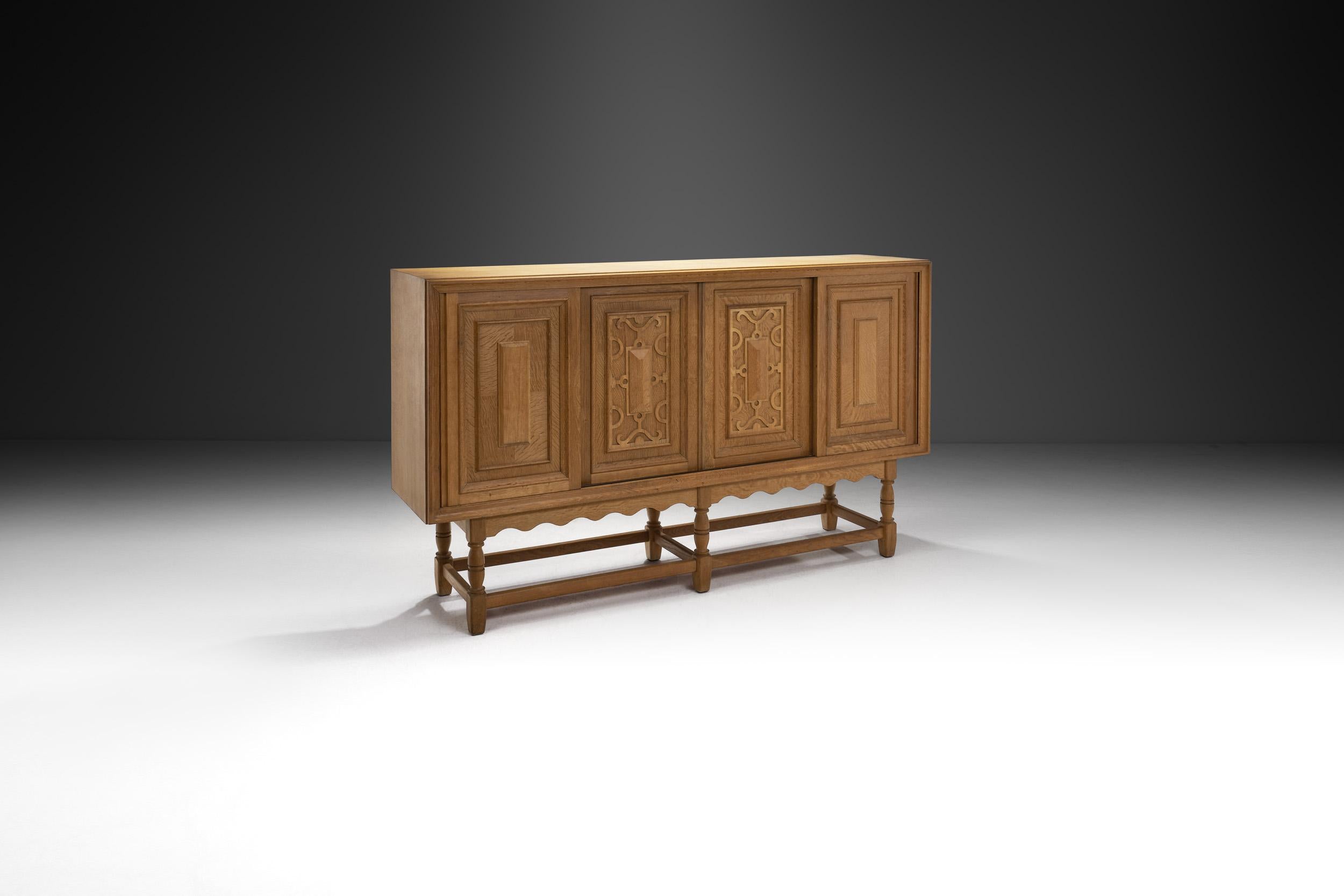 This stunning oak sideboard by Danish designer, Axel O. Röck is enriched with carved details and has a grandiose appearance. The design contains traces of the Baroque style paired with mid-century modern elements.

Axel O. Röck is a lesser known