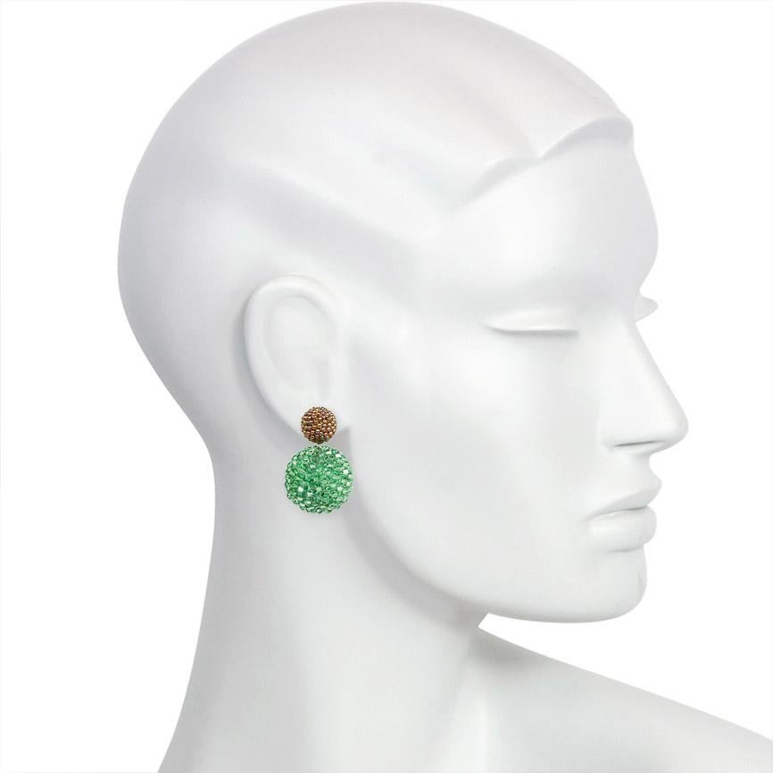 A hand made pair of beaded double ball earrings with brown-green iridescent glass beaded tops and larger peridot crystal beaded bottoms, in 18k gold with post backs.  Axel Russmeyer, Germany.  Dimensions: 1.25