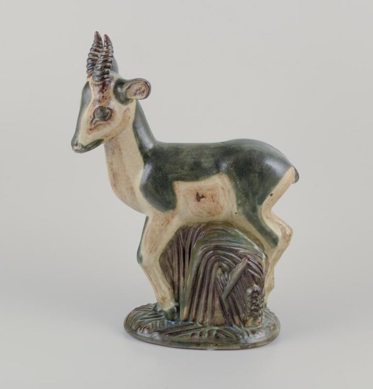 Axel Salto (1889-1961) for Royal Copenhagen.
Large and impressive ceramic sculpture of a deer.
Art Deco style.
Model number 20697.
Approximately from 1940.
Marked.
Perfect condition.
First factory quality.
Dimensions: H 41.0 cm x W 29.0 cm x D 12.5