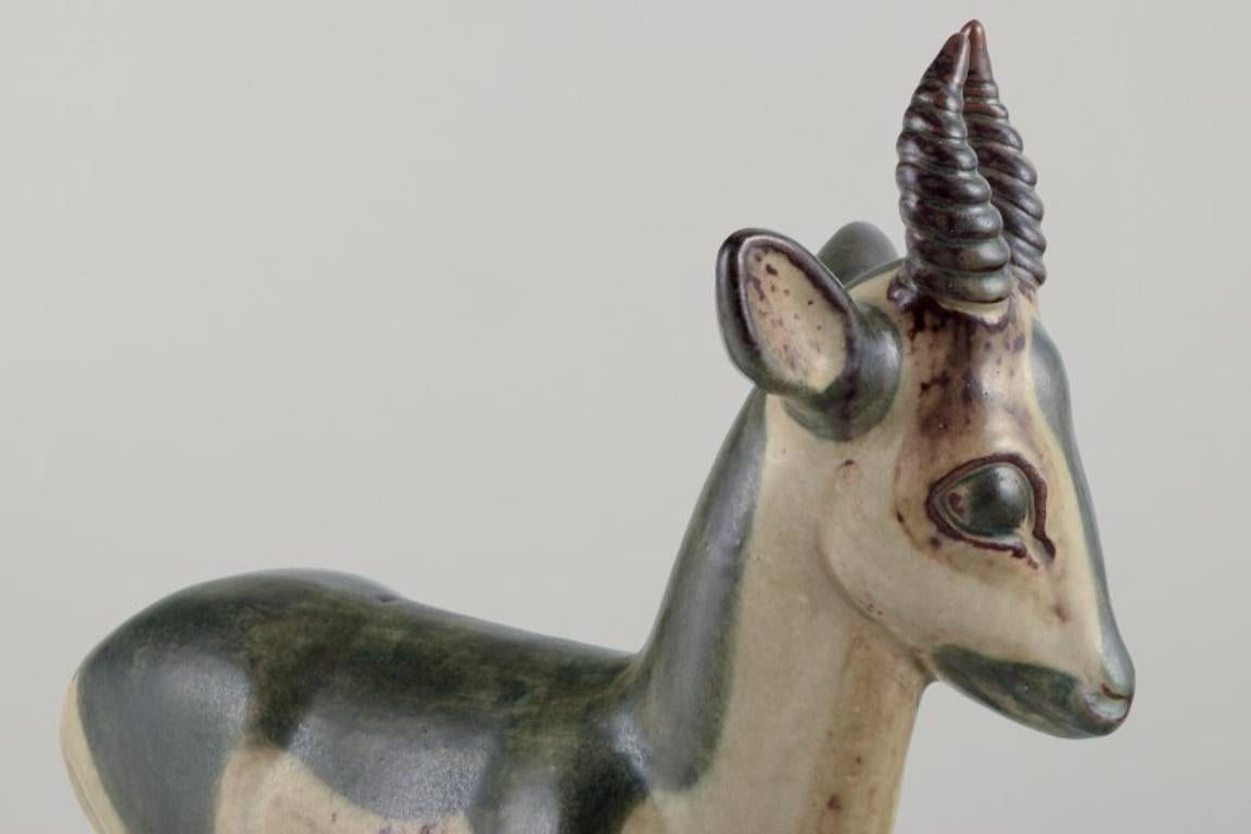 Mid-20th Century Axel Salto for Royal Copenhagen. Large and impressive ceramic sculpture of deer For Sale