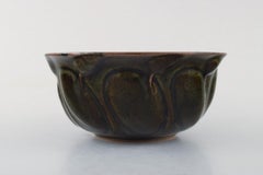 Axel Salto for Royal Copenhagen. Stoneware bowl in aubergine-colored tones