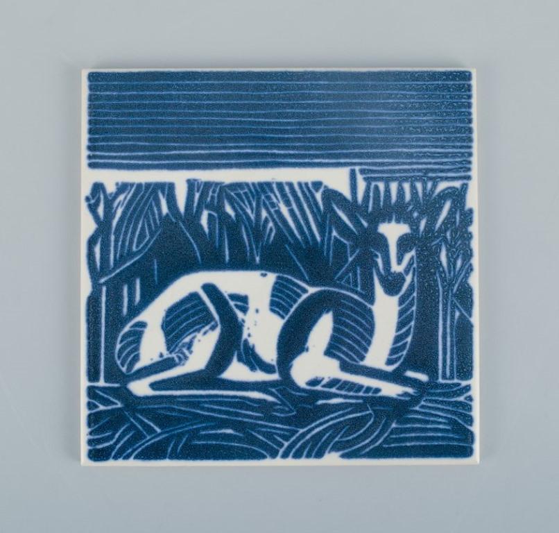 Axel Salto for Royal Copenhagen. Two rare tiles with a motif of reclining deer.
Mid-20th century.
Perfect condition.
Marked.
Dimensions: 15.3 cm.