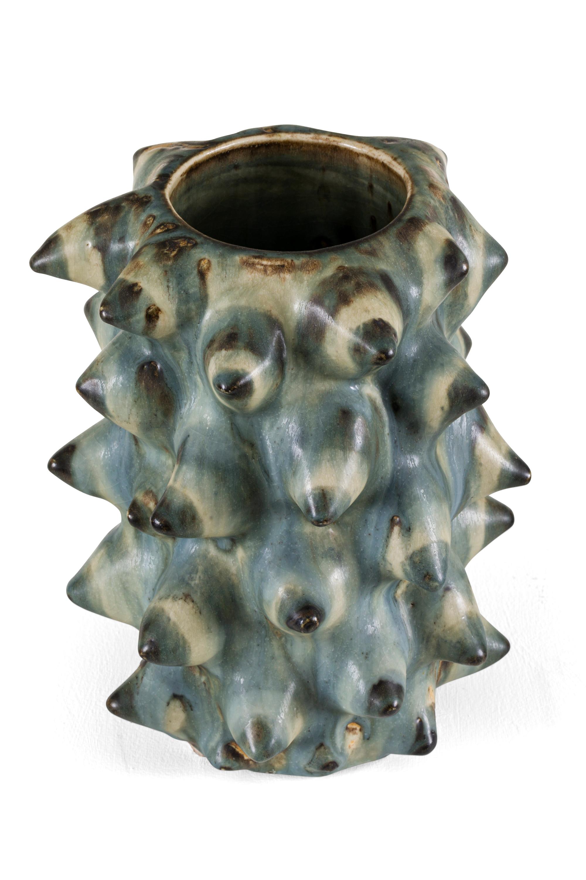 Salto experimented with unusually rich glazes and organic shapes. The sprouting style was a reflection of naturally growing plants. Salto used Chinese and classic glazes such as solfatara and sung, among others. This particular vase has an unusually