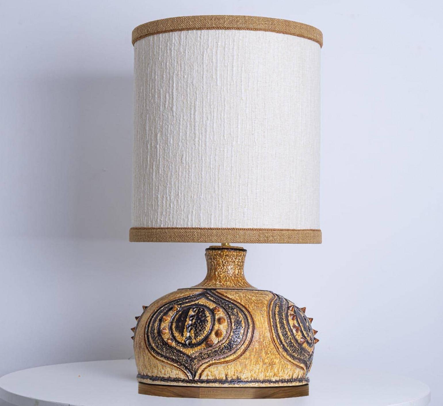 Stunning table lamp with yellow, brown and cognac ceramics by Axella, manufactured in the 1970s in Denmark. Combined with a new custom made lampshade by R. Houben.

This base used to be a pendant, but is now made to a new lamp base with custom shade