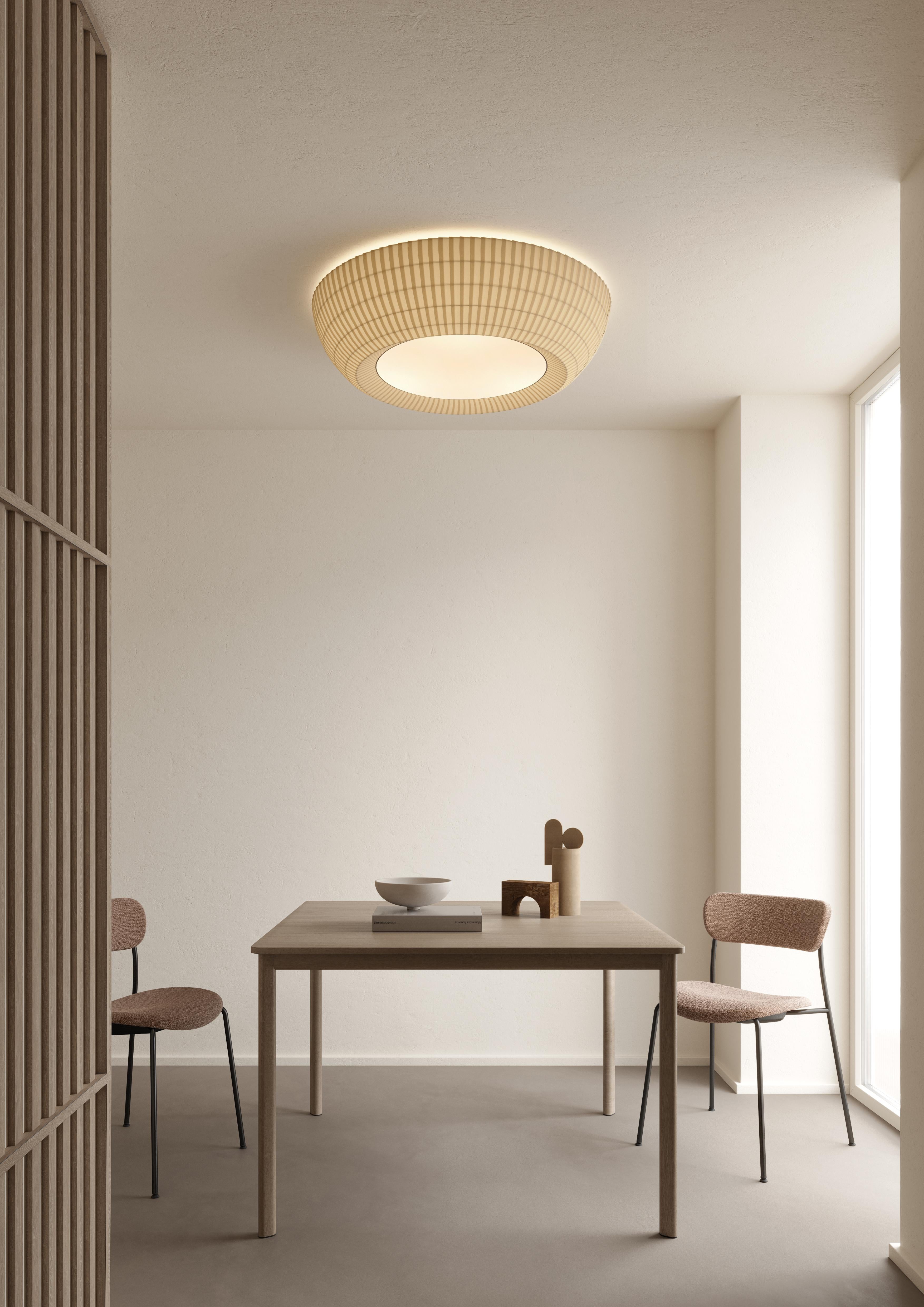 Axolight Bell Extra Large Flush Mount/ Ceiling Lamp in White by Manuel & Vanessa Vivian

The ceiling version of Bell is in continuity with the aesthetic of the pendant one. The lightness given by the fabric, the multidimensionality and the chromatic