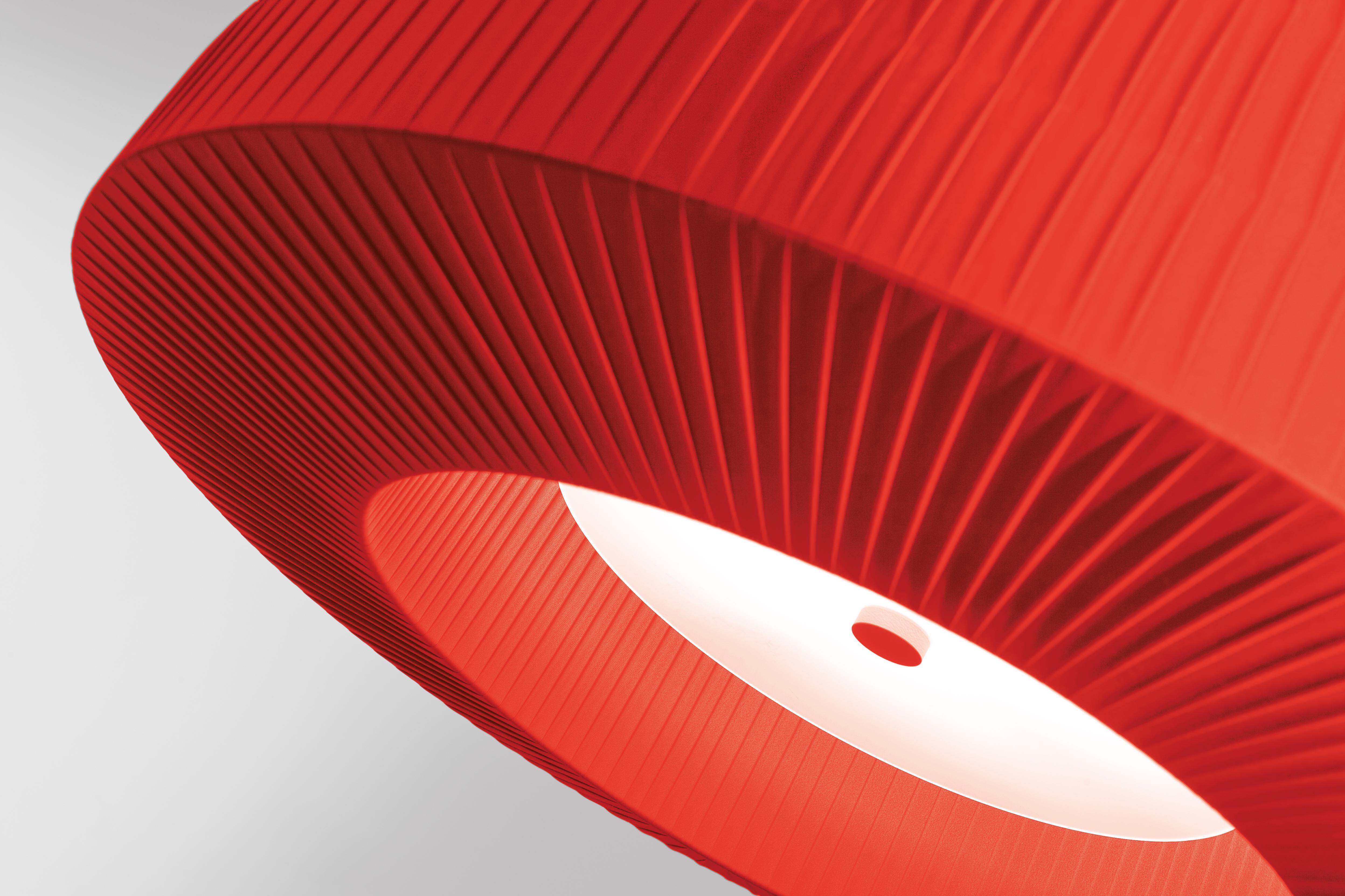 Axolight Bell Large Pendant Lamp in Red by Manuel & Vanessa Vivian

The ceiling version of Bell is in continuity with the aesthetic of the pendant one. The lightness given by the fabric, the multidimensionality and the chromatic variations remain