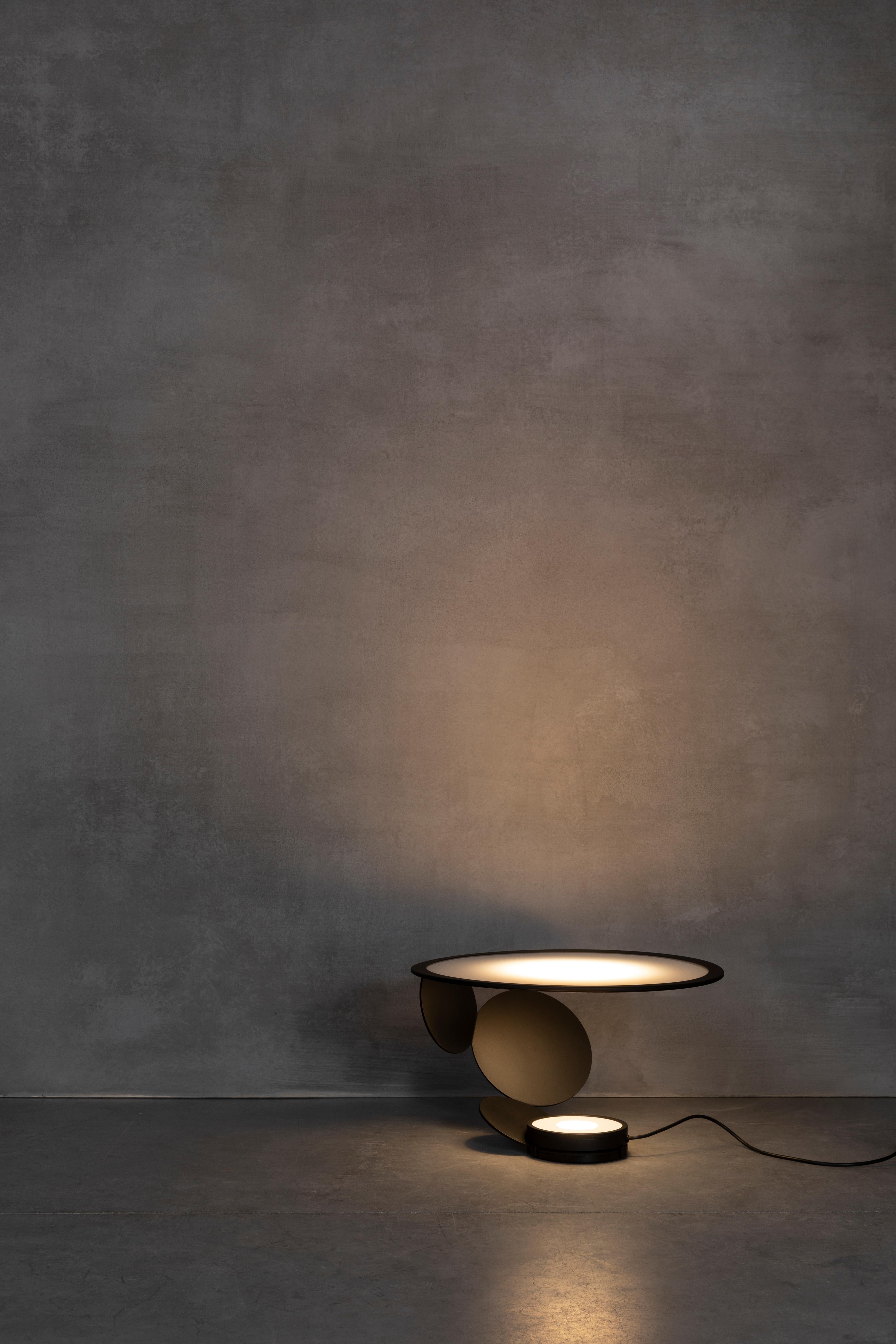 Axolight Cut Medium Table Lamp in Intense Black by Timo Ripatti

Softness of the atmosphere and personalization of orientation. Cut expresses a refined design and an emotional light which does not dazzle, but wraps gently.

Cut is the result of a