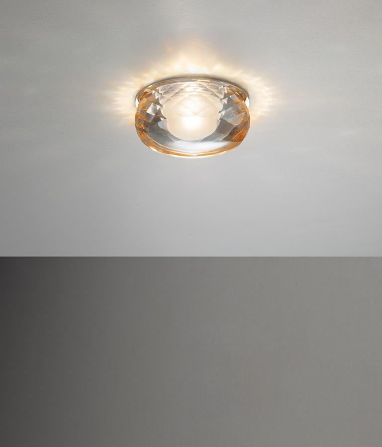 Axolight Fairy Recessed Ceiling Lamp with Chrome Finish and Aluminum Trim in Amber by Manuel & Vanessa Vivian

Multiple reflections and iridiscent symmetries go through the matter to generate new forms. The clarity of aluminum meets the facets of