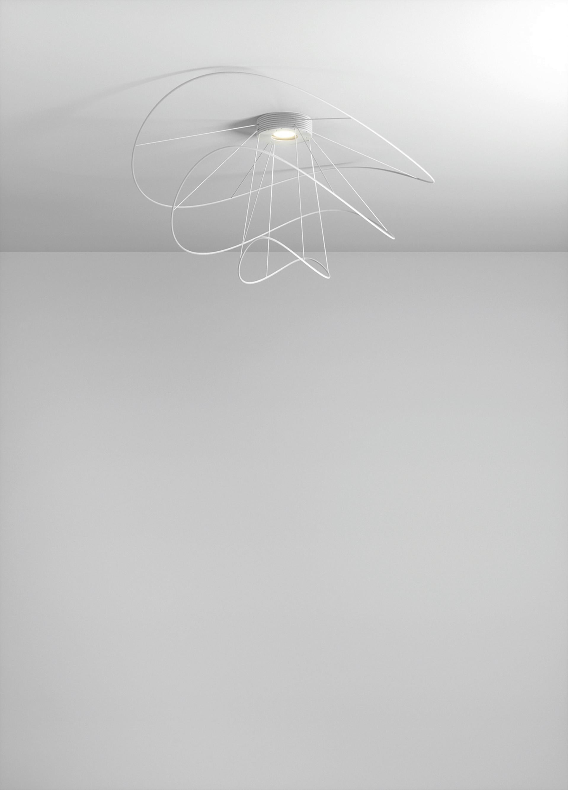 Axolight Hoops 3 Medium Flush Mount Ceiling Lamp in Black by Giovanni Barbato

Lines that dance voluptuously around a nucleus in a changing game of reflected shapes and light. The sinuosity of Hoops is a thin twirling thread, to be followed by the