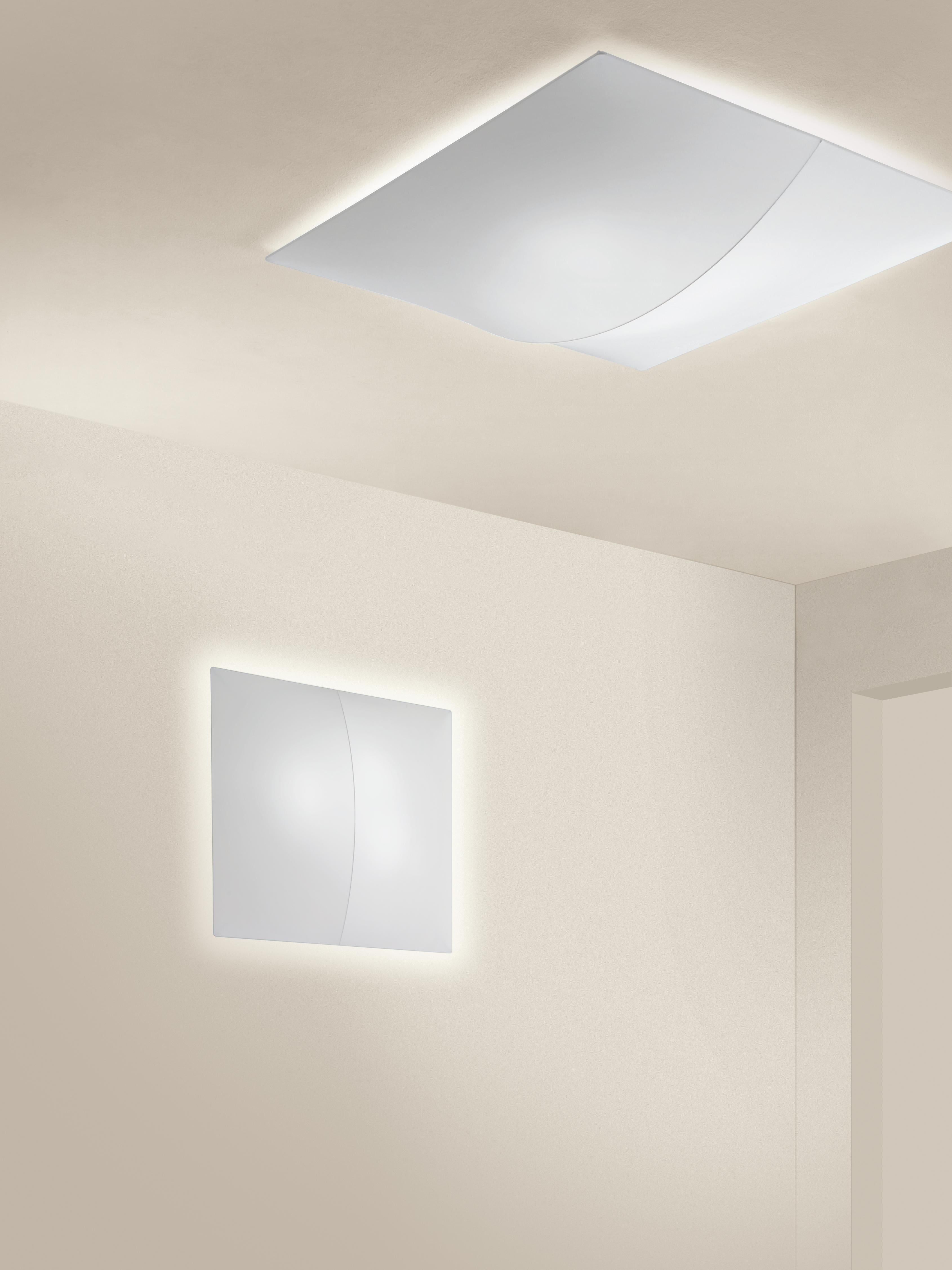 Axolight Large 140 Nelly Wall Lamp in White by Manuel & Vanessa Vivian

Geometric simplicity and a discreet game of light and shade. Nelly is the purity of a white canvas interrupted by a linear trace that gently crosses it, emphasizing reflections