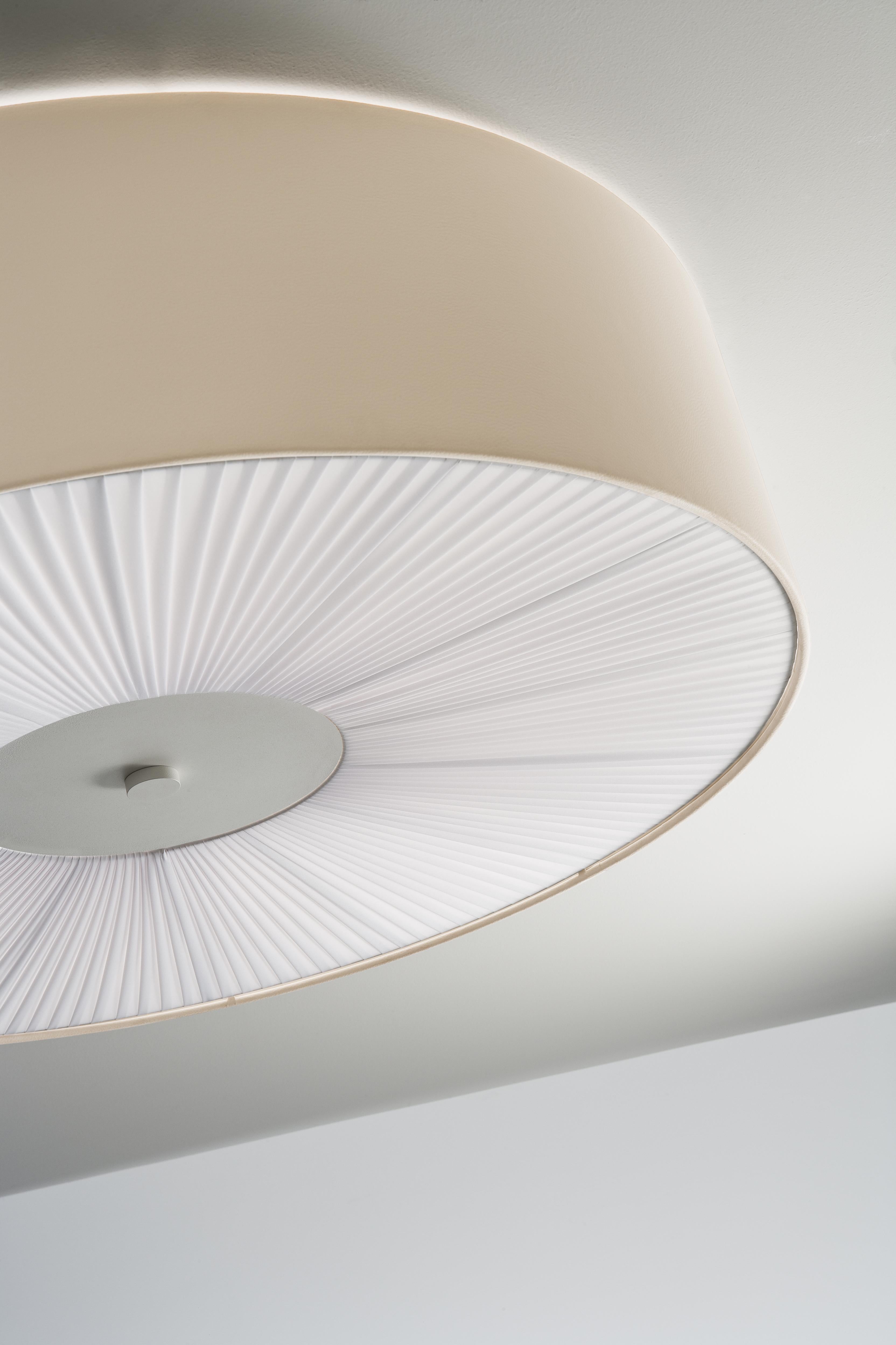 Axolight Skin Large Flush Mount in Ivory White by Manuel Vivian

Refined rationality of perfect form. Skin reveals itself in its simplicity with multiple colors in fireproof eco-leather and different sizes, giving uniqueness and elegance to any