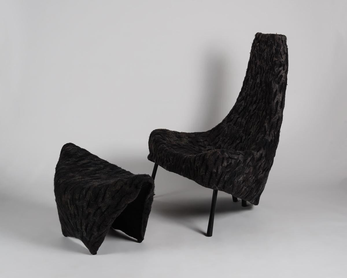 The upholstery of this chair and ottoman, made of finely woven layers of felt, mimics forms in nature, which, like seabed corral, develop of over years of accretion.