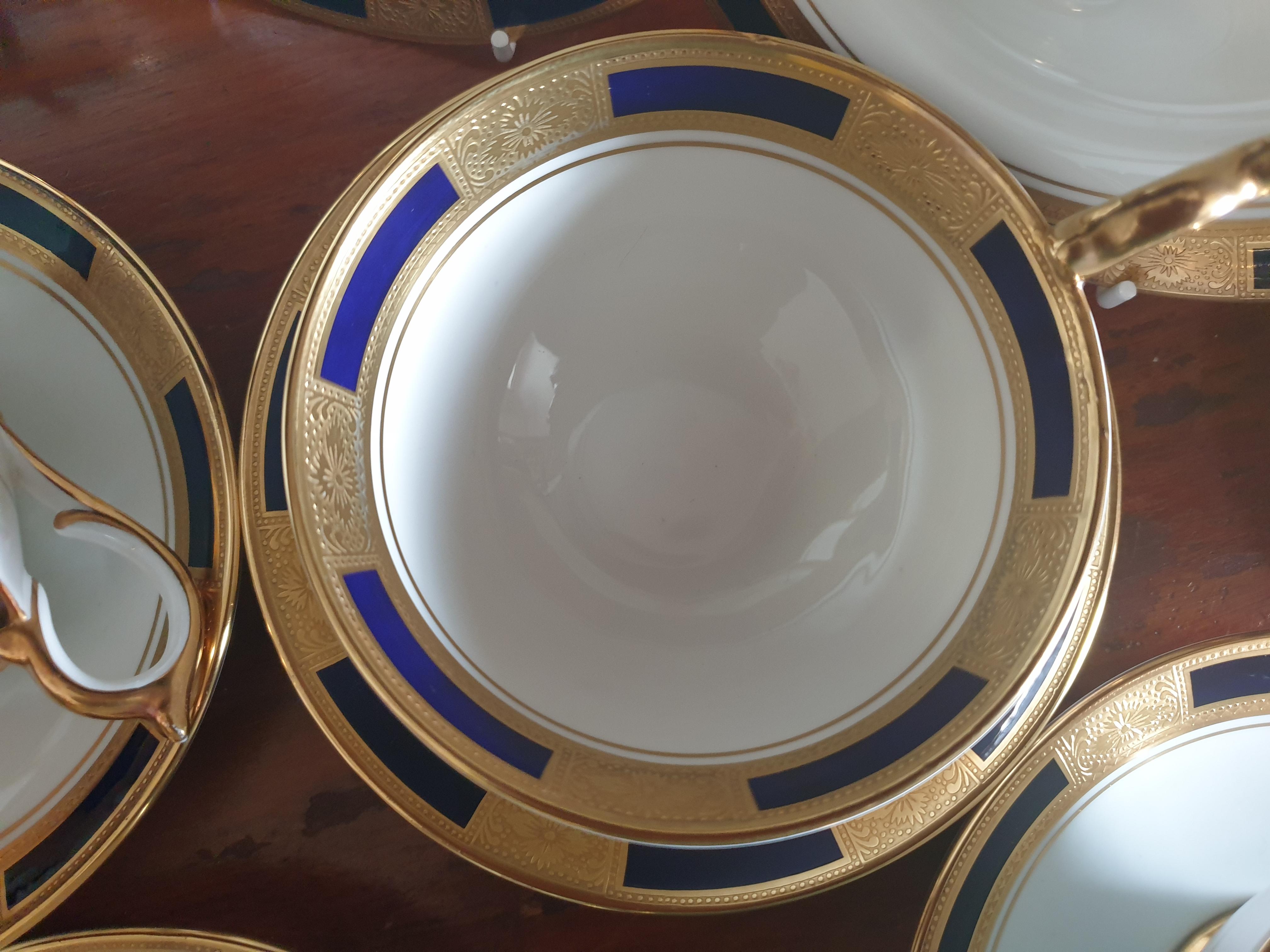 Aynsley English Bone China tea set empress patten cobalt consisting of 10 cups, 10 saucers and 10 side plates. Each piece richly gilded and in mint condition.
