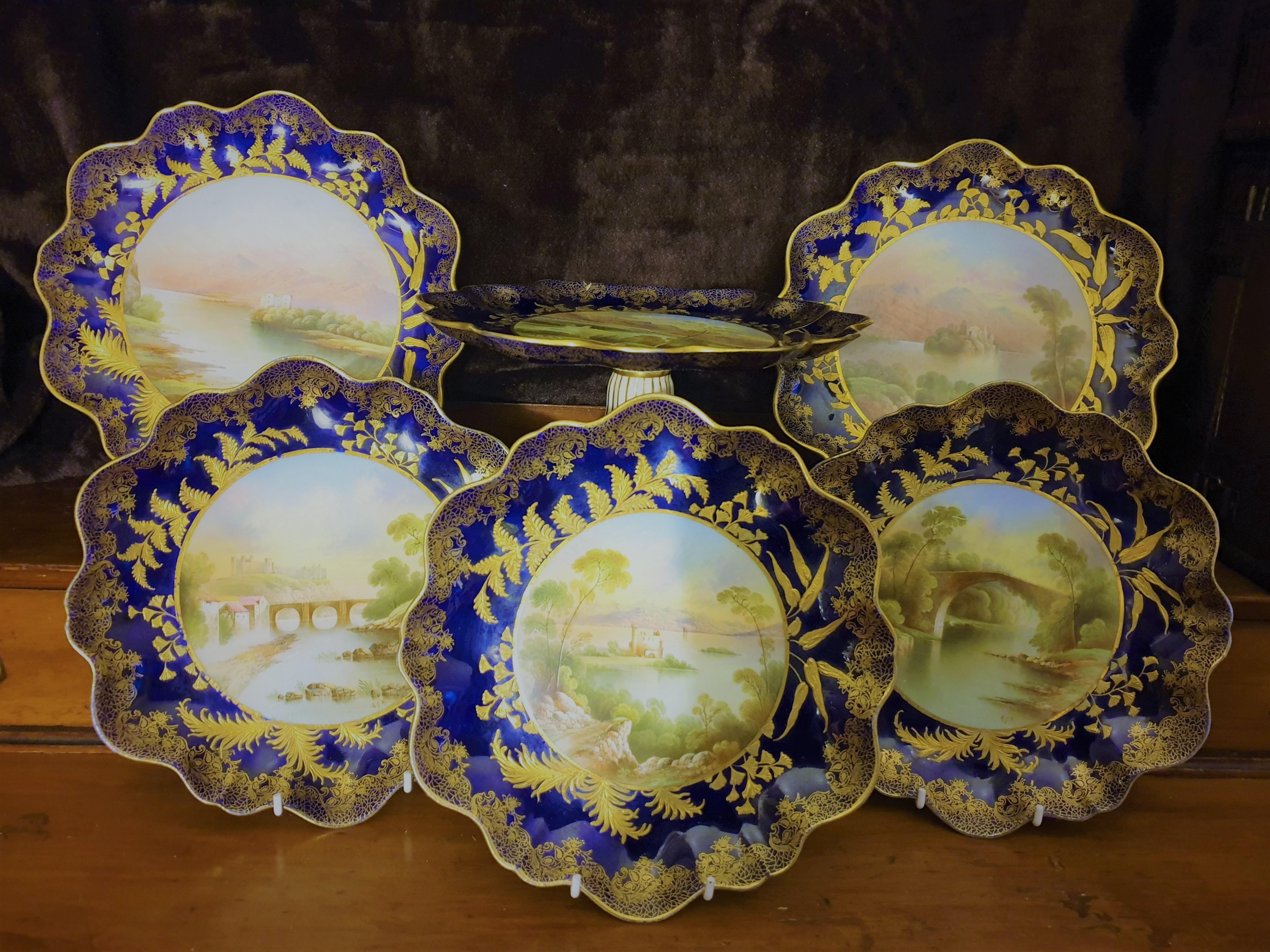 Aynsley signed porcelain dessert service comprising five various plates and a comport, all with handpainted named scenes to include Bridge of Doon, Richmond Castle, Dunstaffnage Castle and Kilchurn Castle. R J Keeling was an artist working for