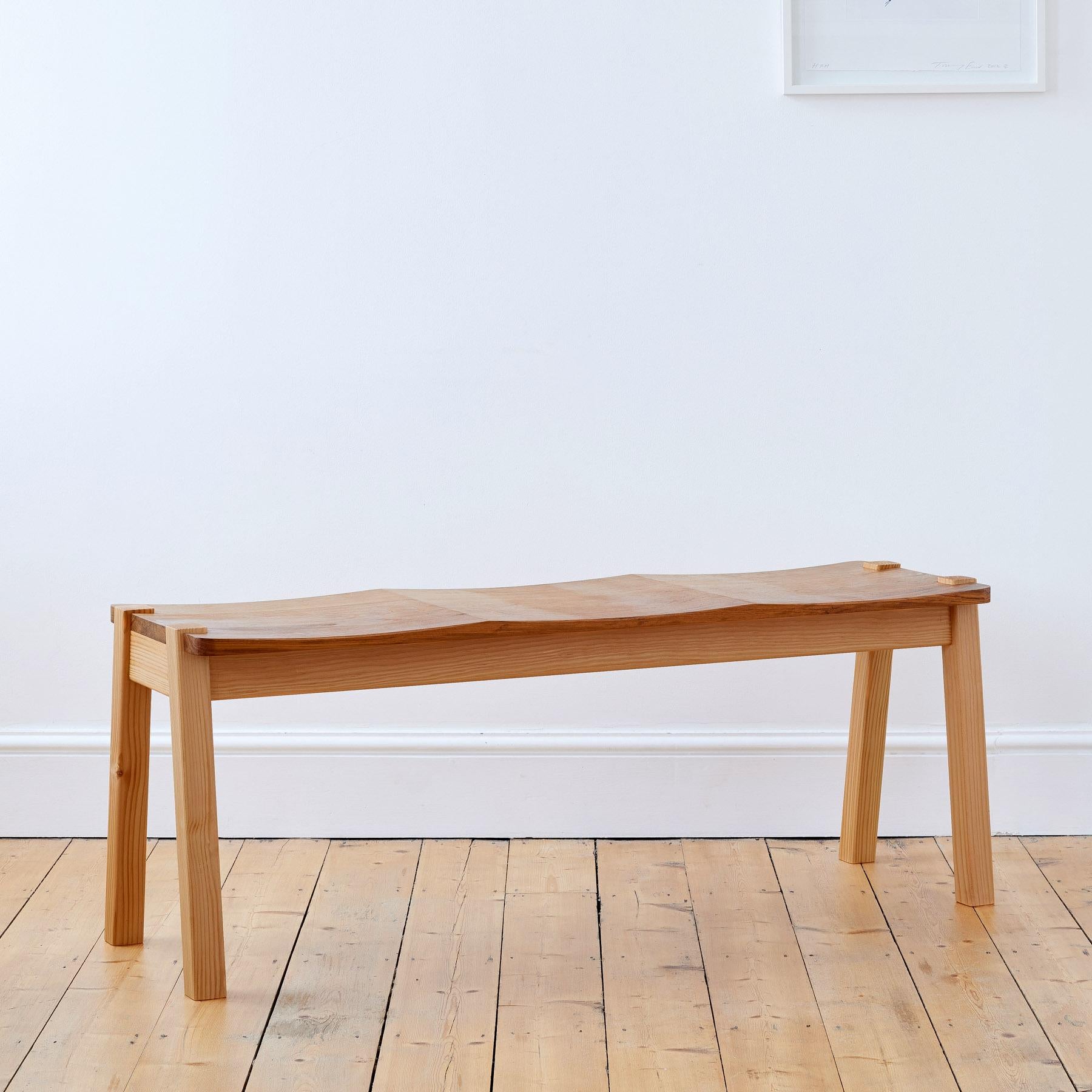 Sophisticated and elegant, the Ayrton Bench is sculpted with subtle curves providing luxurious comfort and a striking silhouette. 

A modern statement in any home, its minimal design marries two contrasting yet complementary wood types - rich elm
