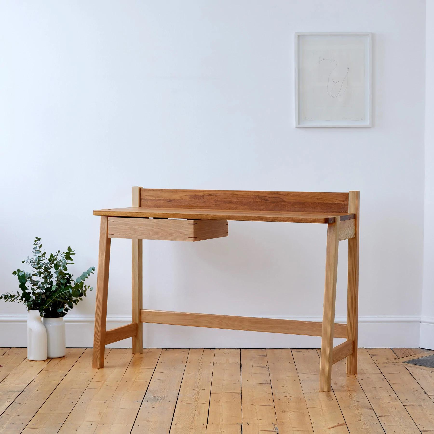 The Ayrton Desk has an abundance of character and effortless style. Boasting elegant lines, the desk features a floating drawer, joined with contrasting elm splines.

A modern statement in any home, its minimal design marries two contrasting yet