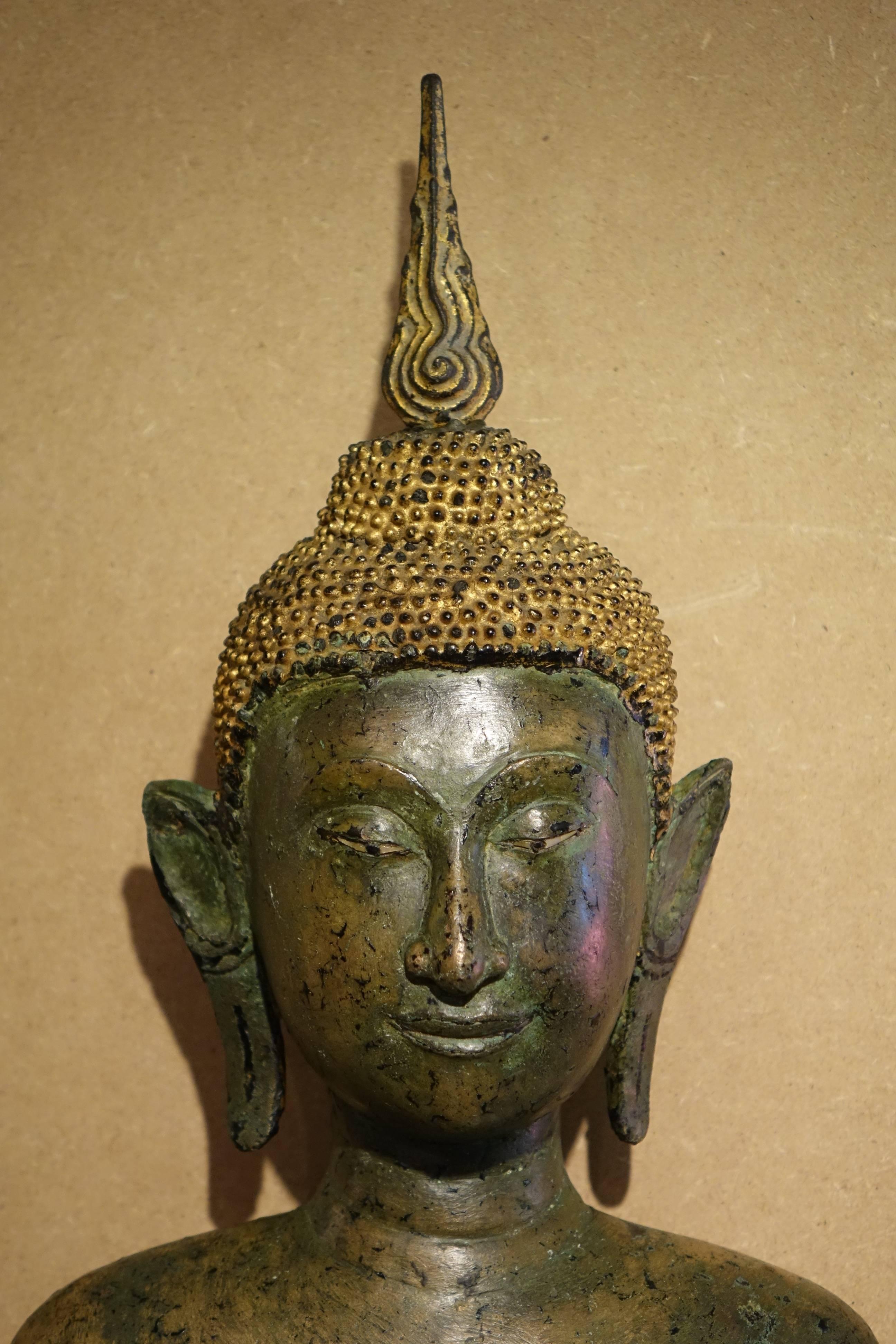 Ayutthaya style, bronze figure of Buddha 17th century, standing in samabhanga, both hands in Abhayamudra, wearing long cloak covering both shoulders, his face with downcast expression,, aquiline nose, smiling lips, elongated earlobes, curled