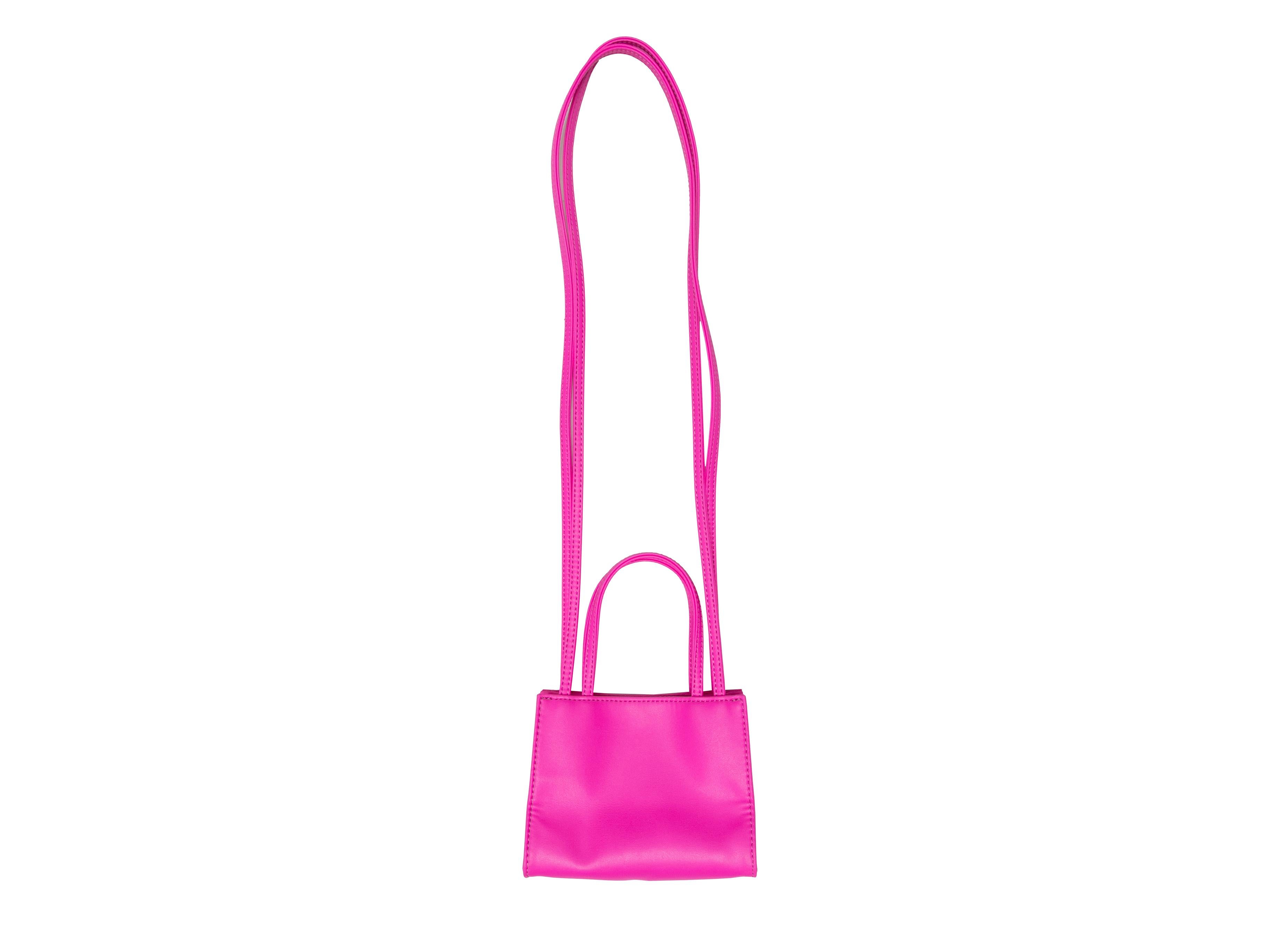 Azalea Telfar Small Shopping Bag Tote. The Small Shopping Bag Tote features a vegan leather body, dual flat top handles, dual crossbody straps, an embossed front logo, and a top magnetic closure. 6.5