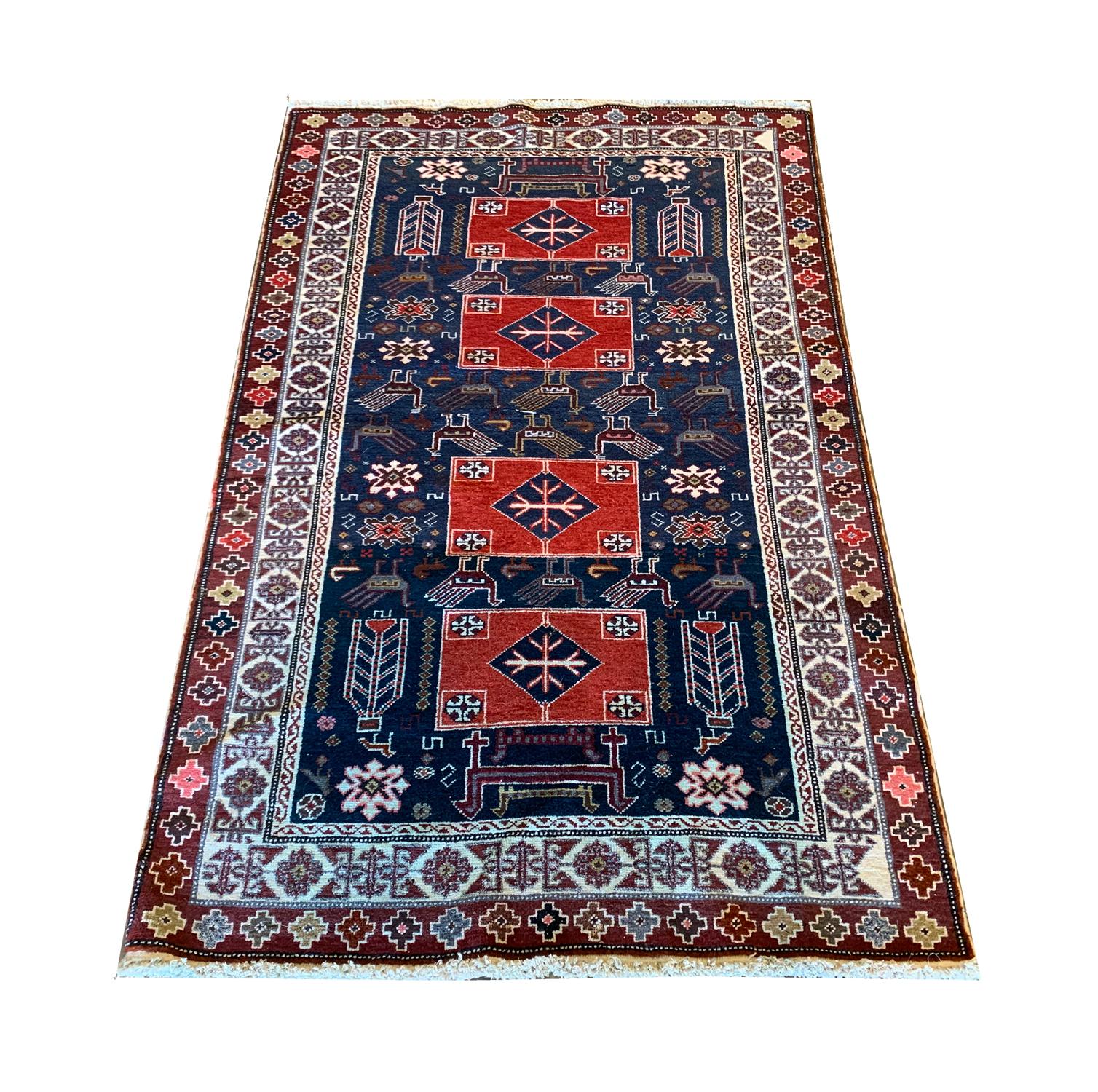 This fine wool rug is an excellent example of antique Caucasian rugs. Woven by hand in the 1880s with a bold statement design. The central pattern has been woven on a deep blue field with stand out red medallions and animal motifs surrounding the