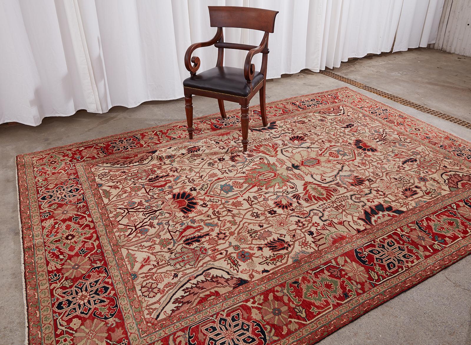 Colorful hand-knotted Turkish wool rug made in the Persian Heriz Serapi style featuring an arts and crafts design. Finely woven with intricate patterns over a cream field having moss green accents throughout, which compliment the arts and crafts