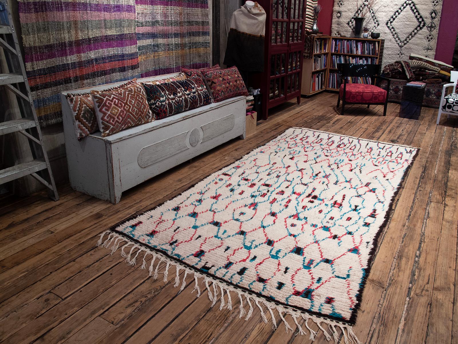 A lovely Moroccan Berber rug from the Azilal province in the Central High Atlas Mountains with a delicately and whimsically drawn grid design on a white background. Generous proportions for the type.

The rugs of this remote region have remained a