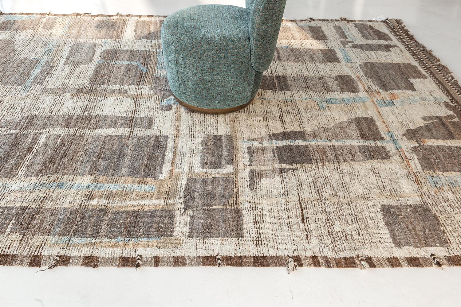 Aziza is a warm and lustrous wool rug with a unique play of colors and irregular shapes. This pile weave has earth tones embossed textures and unique tassel detailing which makes this piece highly sought after. Mehraban's Atlas collection is noted