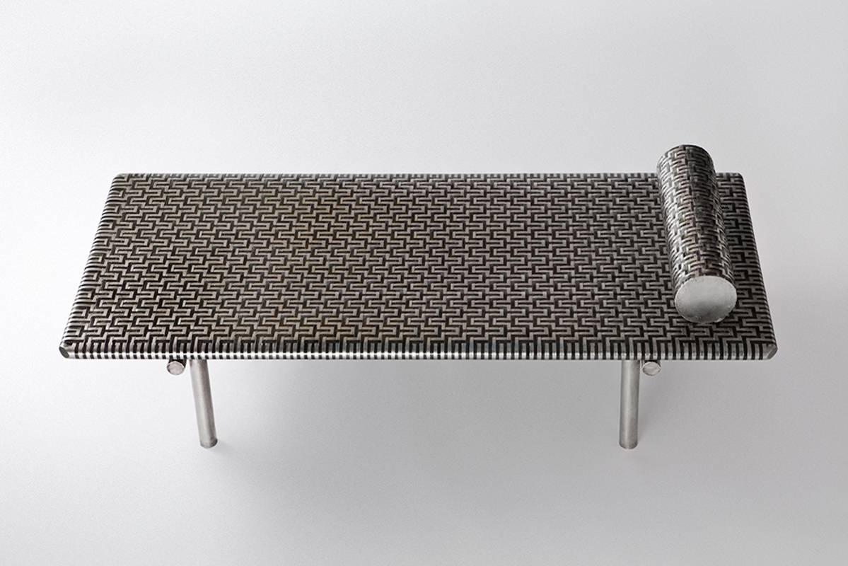 Aztec daybed, signed by Michael Gittings
Aztec daybed
Woven patinated and brushed stainless steel.
Dimensions: 195 cm, 80 cm, 40 cm
Limited edition of 3

Michael Gittings
Melbourne based designer Michael Gittings aims to
challenge