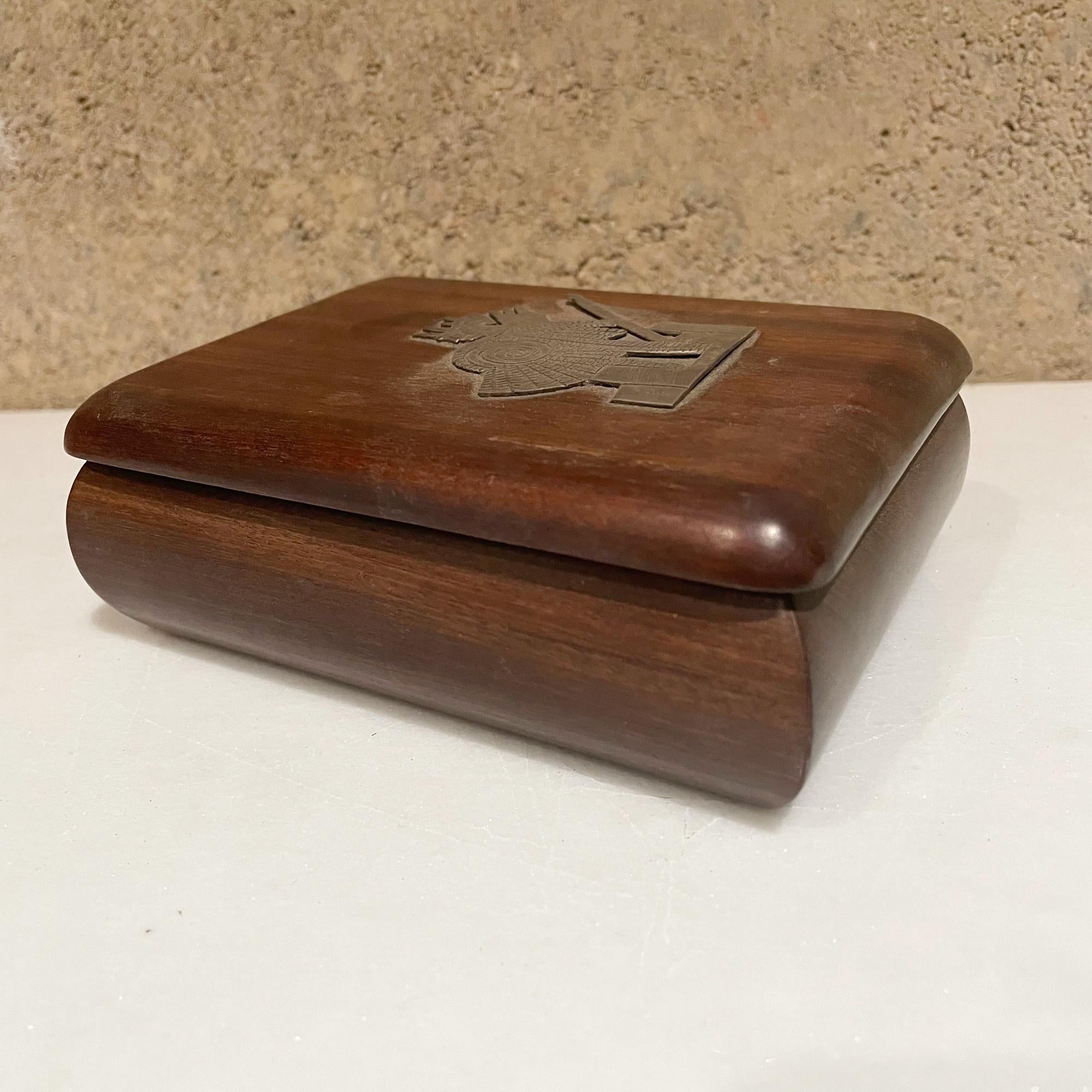 Box
From Mexico small wood jewelry keepsake box hand carved in exotic Mahogany, finely crafted.
Beautifully polished with elegant curves.
Cover Lid is embellished with an emblem of a Mexican Aztec warrior, made in silver.
No signature,