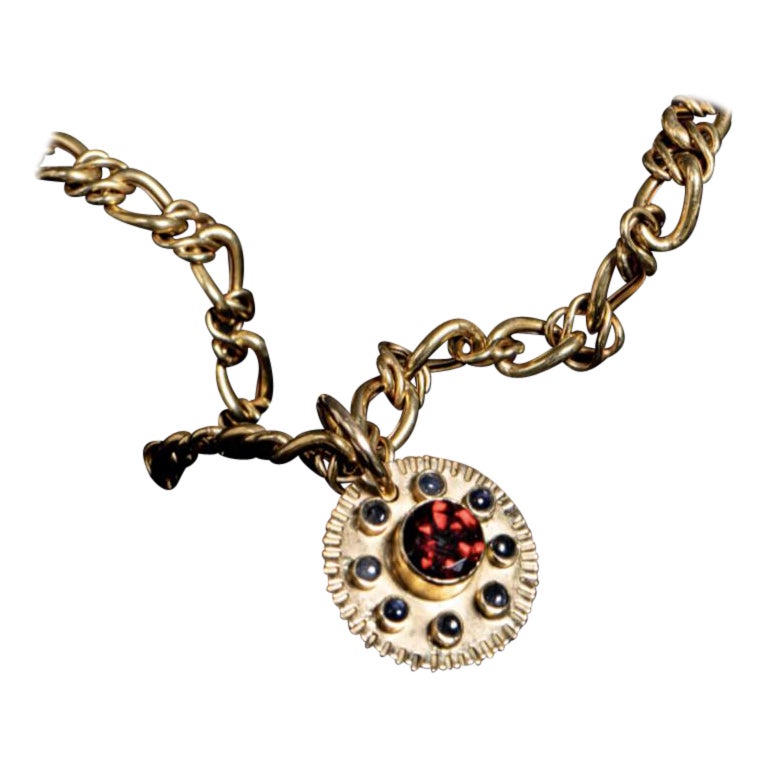 Colgante Sol Azteca en Oro de 18k con Granate y 8 Zafiros en venta