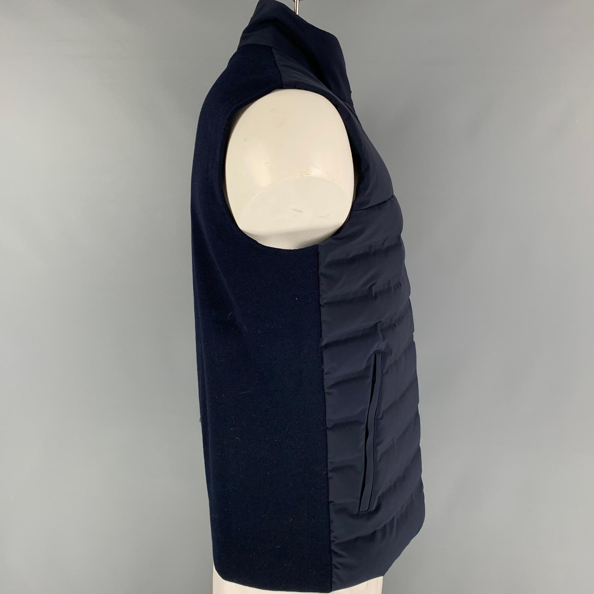 AZTECH 'Dale of Aspen' vest comes in a navy quilted polyamide with 'Dermizax' waterproof technology featuring a high collar, sleeveless, front pockets, and a full zip up closure. 

New With Tags. 
Marked: L
Original Retail Price: