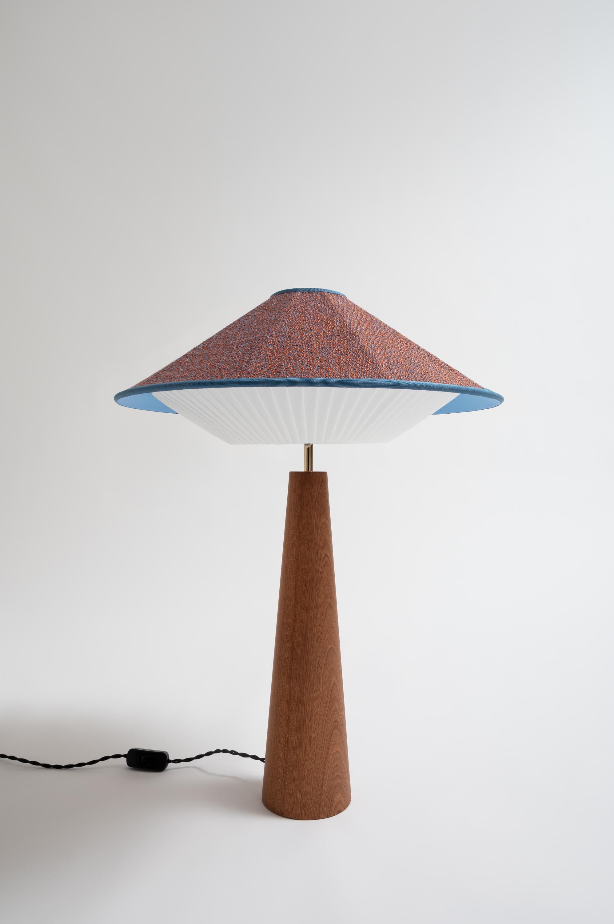 Azure Otto Table Lamp by Servomuto
Dimensions: D 50 x H 67 cm
Materials: Upper Lampshade: Rubelli / Dedar fabric. Lower Lampshade: Pleated pongé bends. Structure: Mahogany base and brass-plated iron details.
Weight: 3 Kg. 

Derived from the