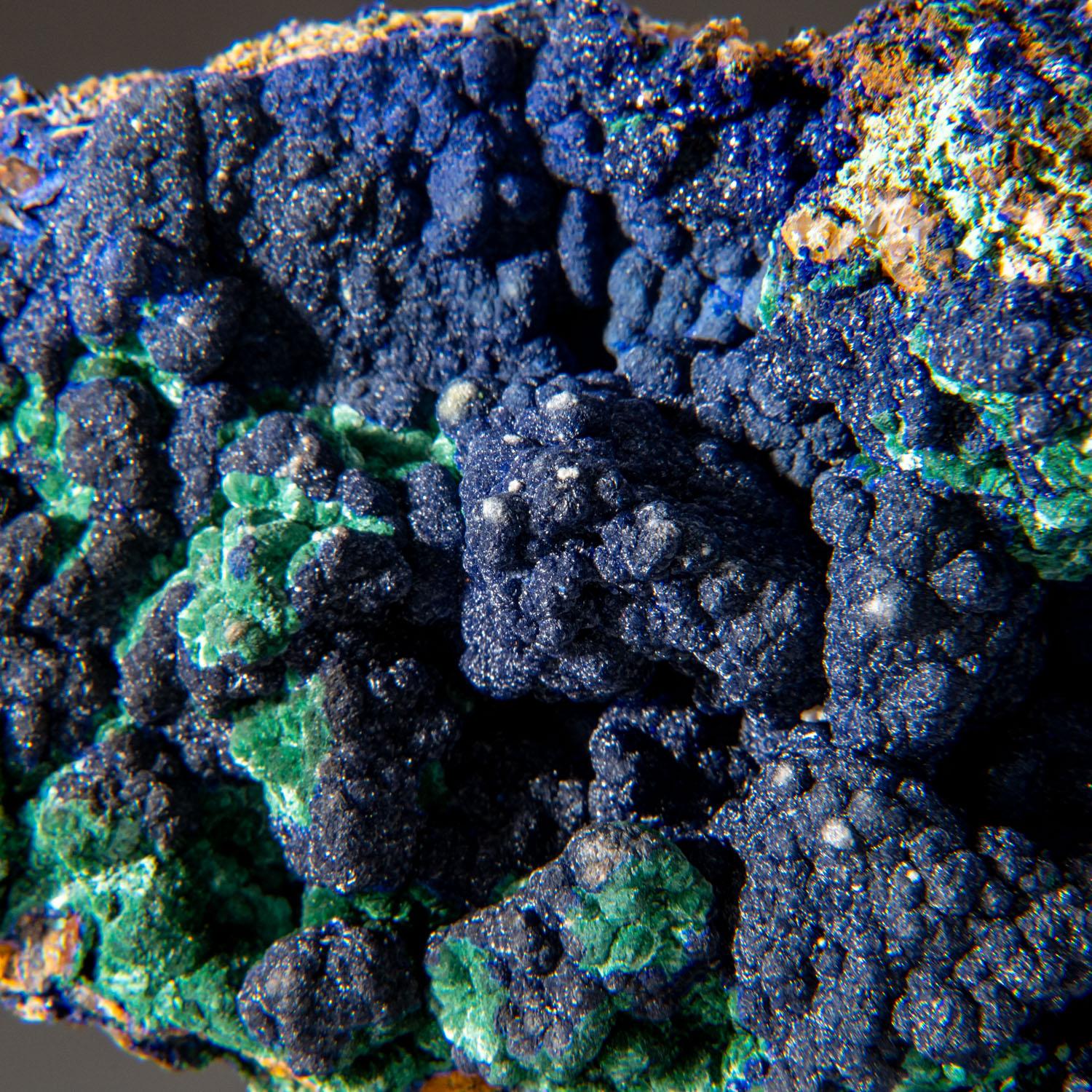 From Ahouli Mines, Aouli, 7 km northeast of Mibladen, Zeida-Aouli-Mibladen belt, Midelt Province, Morocco

Rich specimen of bright-blue lustrous azurite crystals on powdery green malachite microcrystals. The azurite is internally transparent making