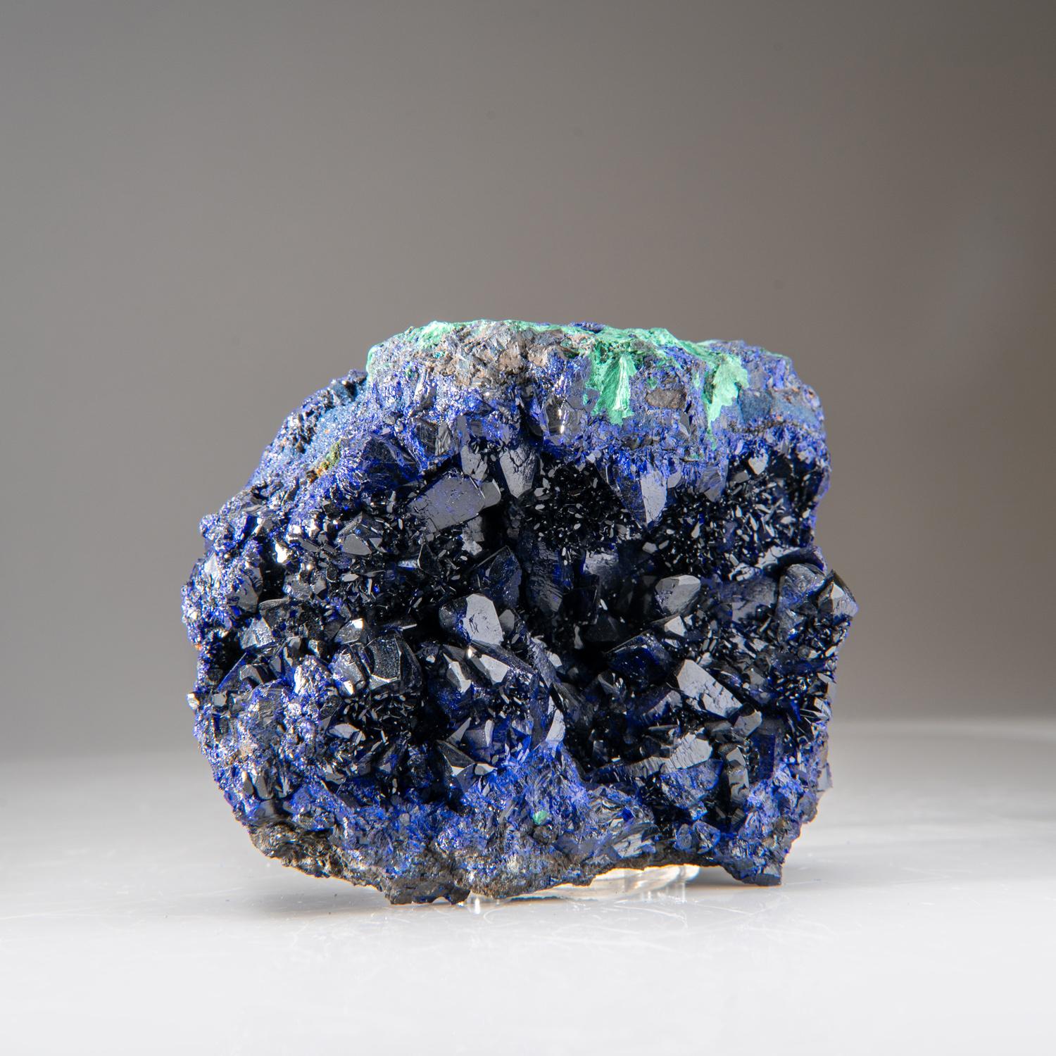 From Liufengshan Mine, Guichi, Anhui Province, China

Lustrous dark-blue azurite crystals lining cavities front and rear on a crystallized mass of azurite with with fibrous green malachite crystals around the edges of the specimen. The translucency