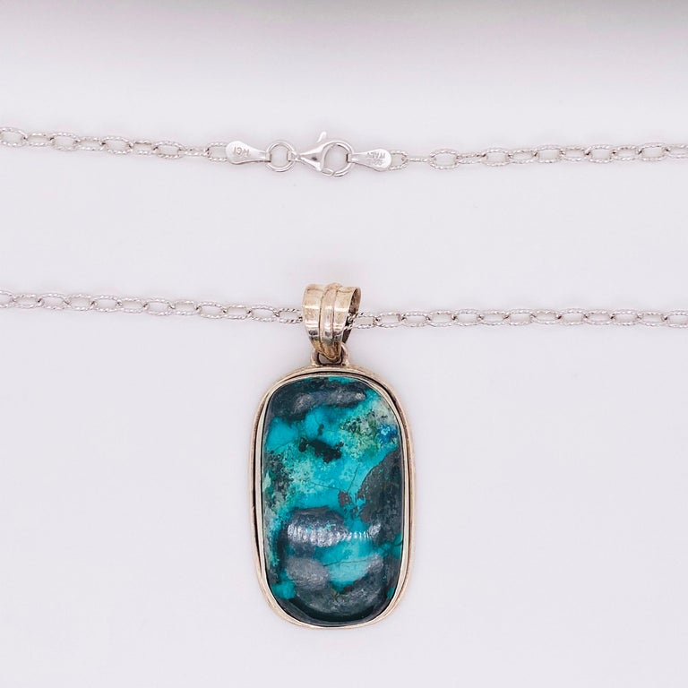 Genuine azurite gemstone.  This pendant was hand fabricated out of the finest sterling silver bezel material.  People are always surprised to learn that our bezels are all hand done by starting with a strip of sterling silver.  The azurite is very