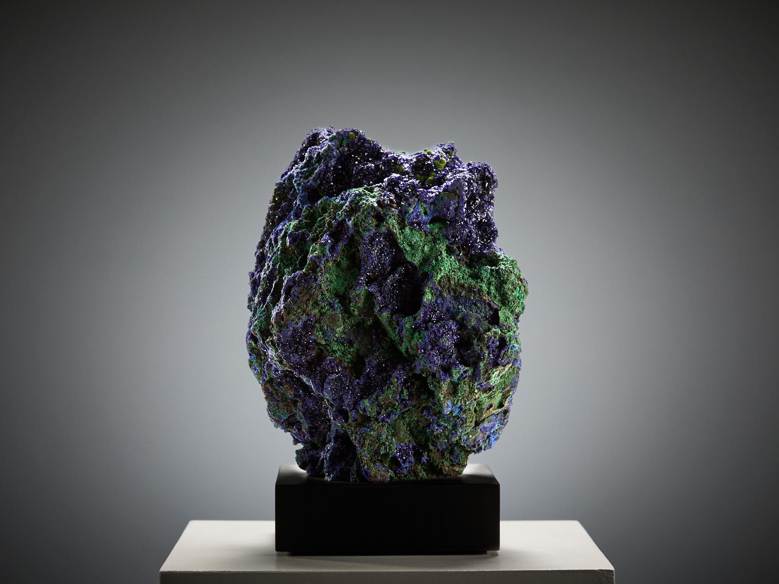 A magnificent large specimen from Guangdong, China, displaying a captivating blend of deep blue azurite and rich green malachite. The surface is covered with crystals of varying sizes and textures, creating a dynamic interplay of light, colour, and