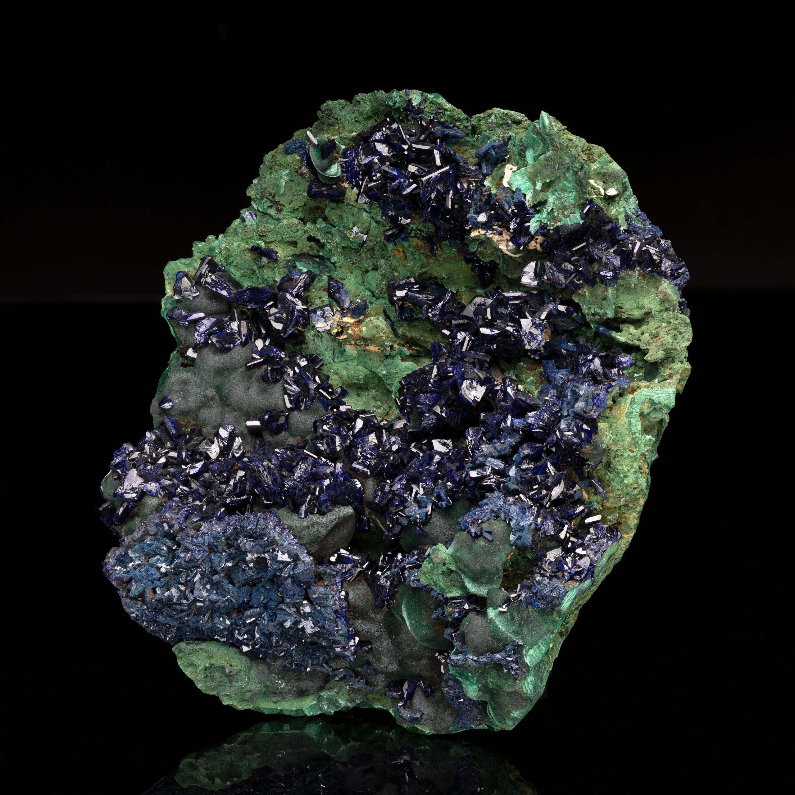 This specimen from Laos displays a stunning deep-blue azurite on a verdant backdrop of light green malachite. Offering sparkling luster and texturally fascinating, this combination piece displaying museum grade crystallization of these copper-based