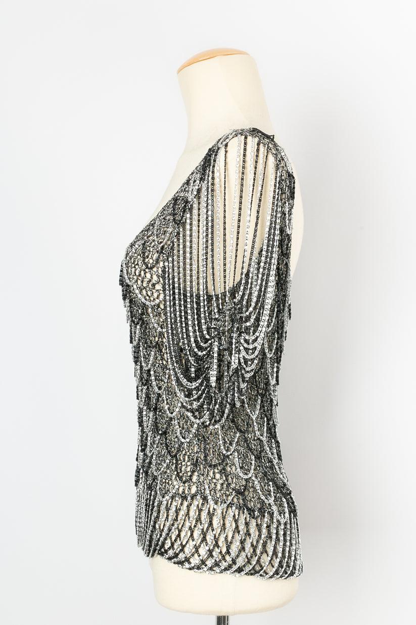 Azzaro - Top in black and silver lurex with small chains. No composition or size tag, it fits a size 36FR.

Additional information:

Dimensions: 
Shoulders: 40 cm (15.75