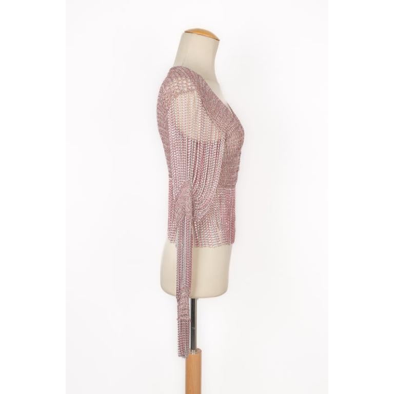 Azzaro - (Made in France) Top from the 1970s made of pink and silvery lurex, and ornamented with chains. No size, brand, and composition label, it fits a 36FR.

Additional information:
Condition: Very good condition
Dimensions: Shoulder width: 37 cm