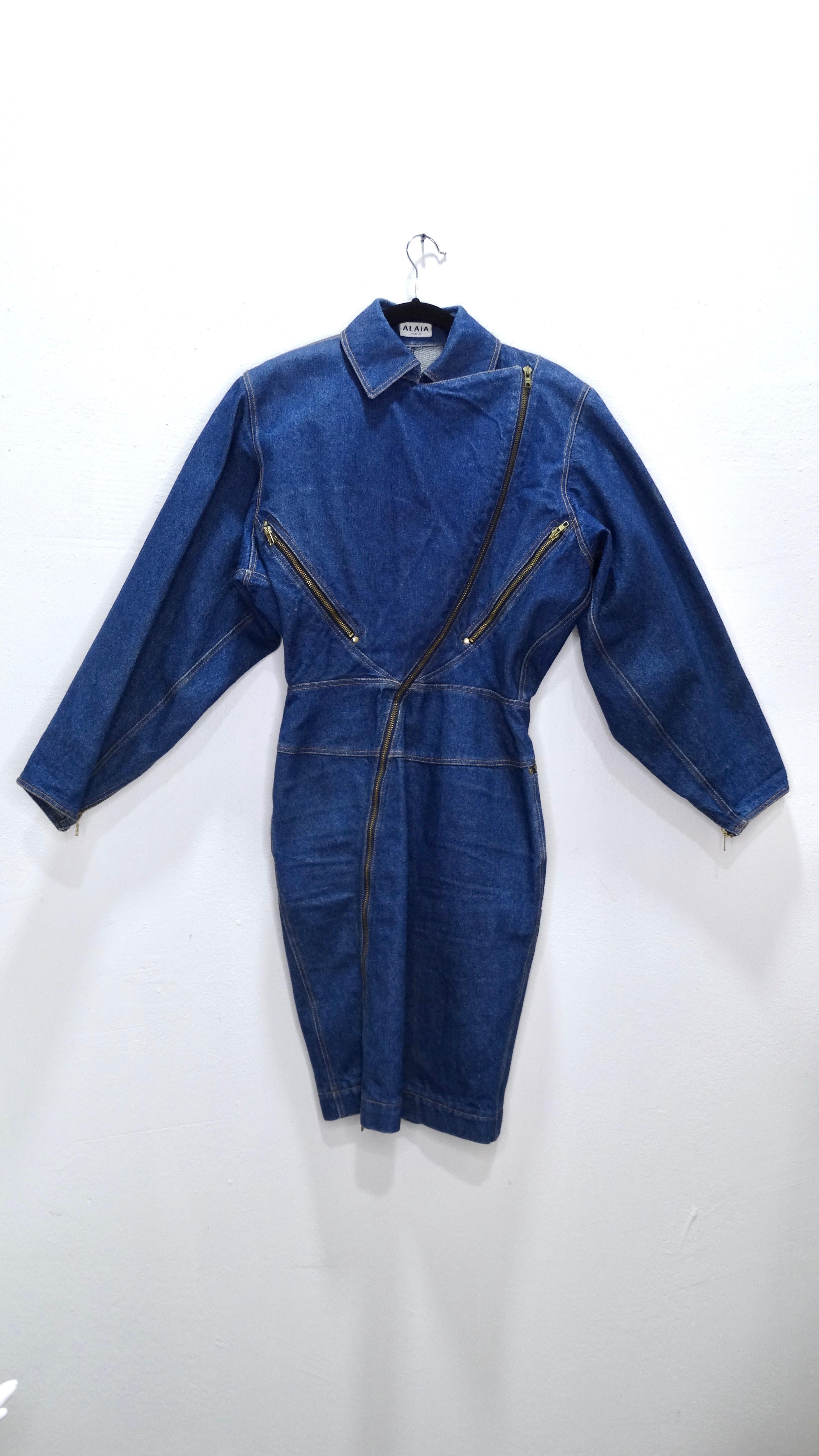 A fabulous structured denim dress to compliment your wardrobe! This Azzedine Alaia is from a 1986 collection featuring a motorcycle style with a unique asymmetrical zipper closure, dolman sleeves with zippers, and a collar clip-closure. No stretch,